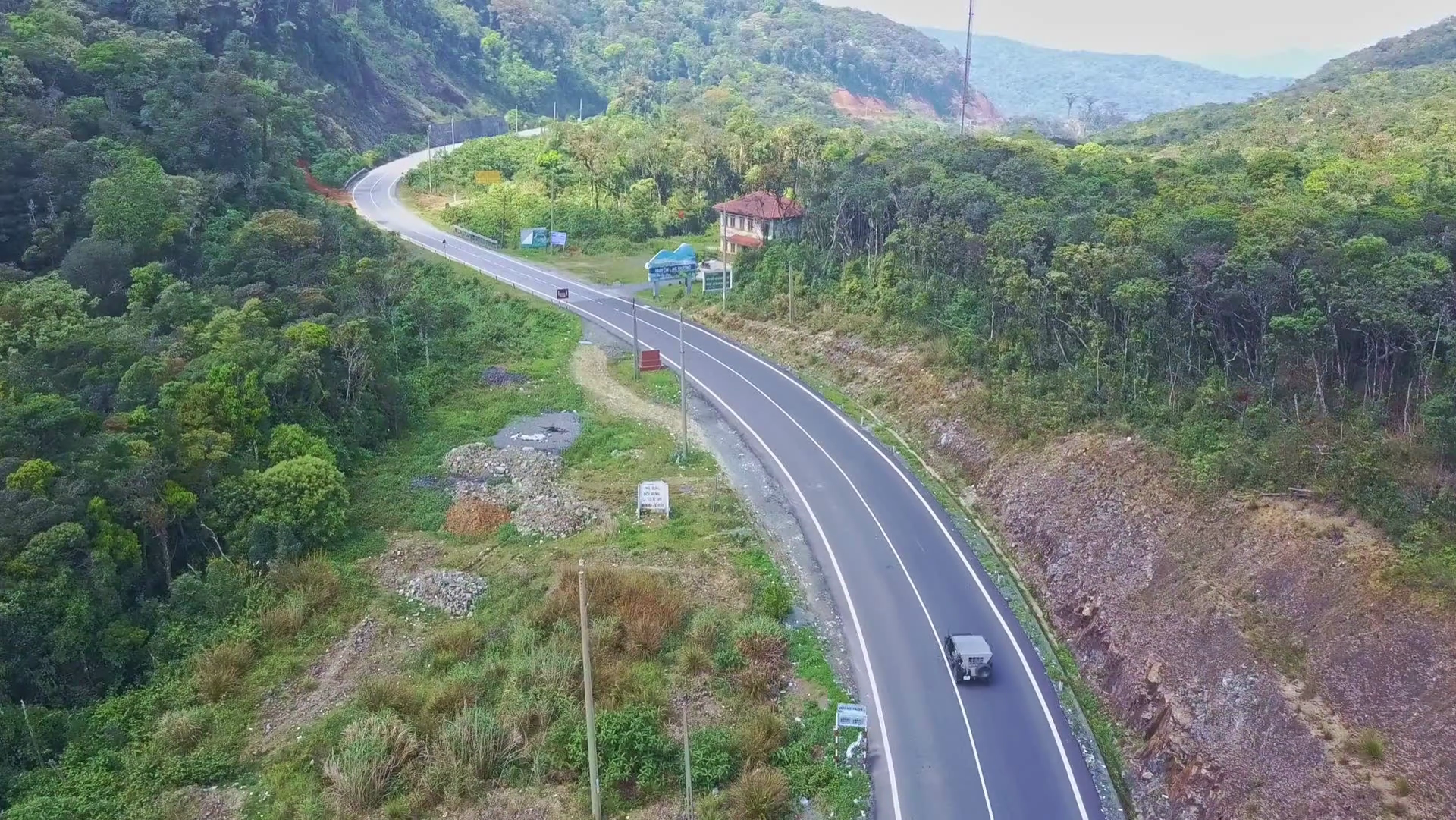 Flying Camera Shows Car Driving along Mountain Road and Motel Stock ...