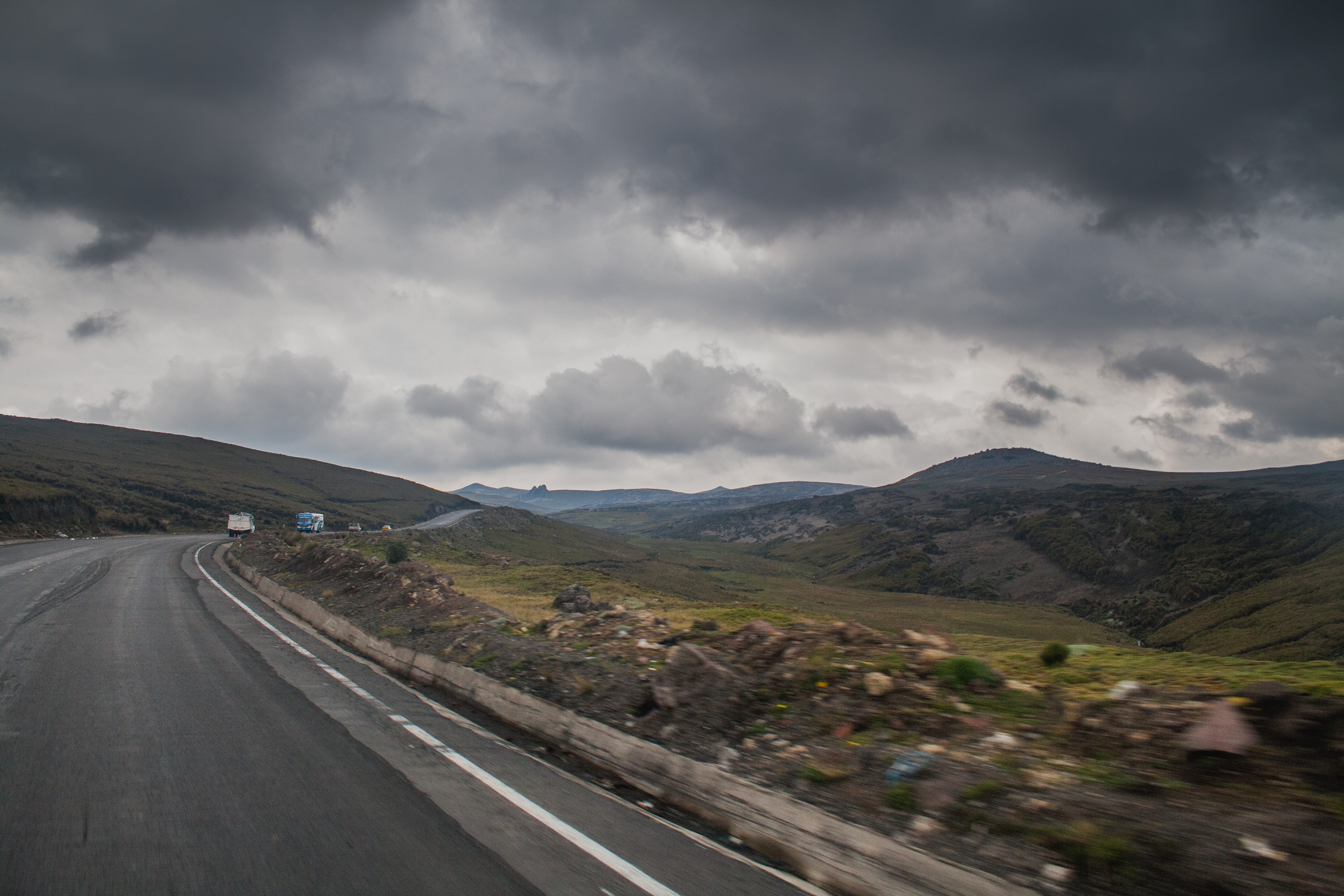 Road near brown stone during cloudy photo