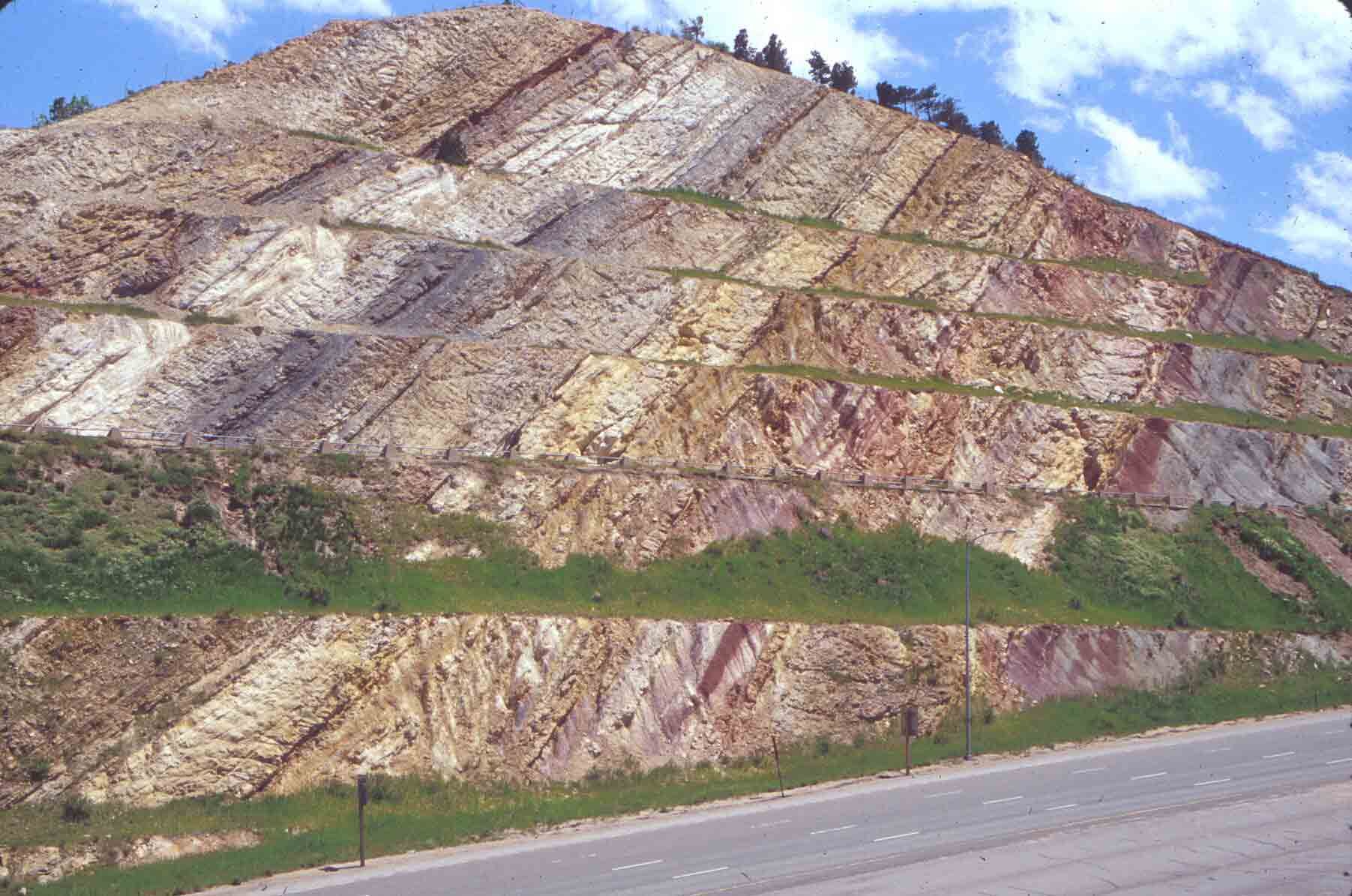 TILTED ROCK LAYERS: The sedimentary layers in this large roadcut ...