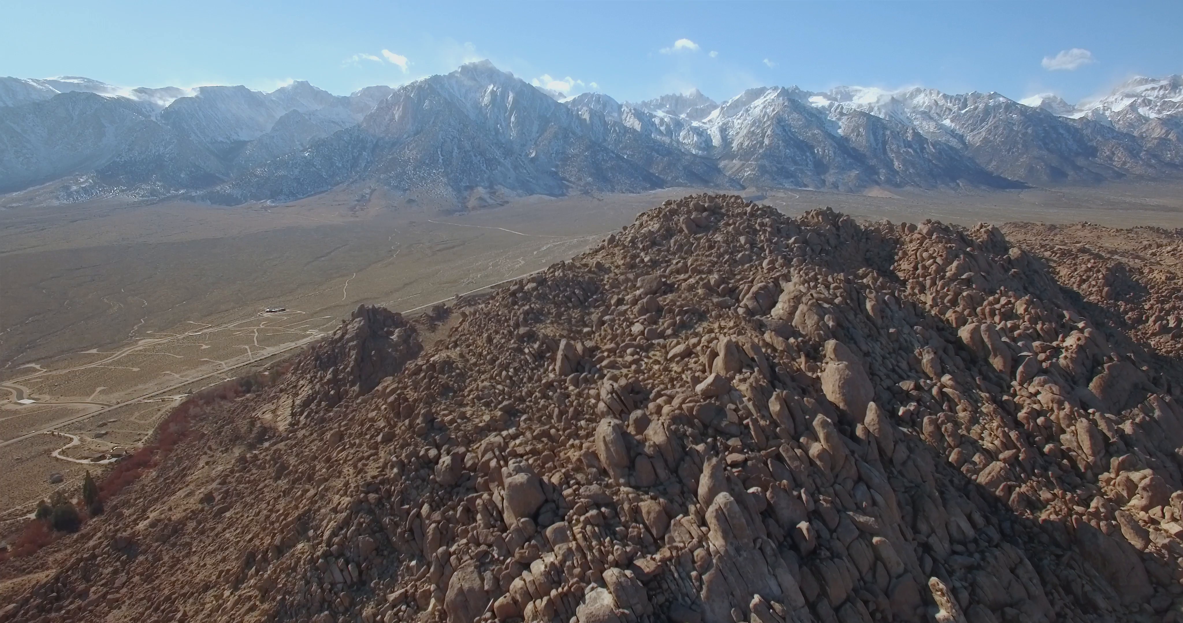 Desert Snowy Mountain / Aerial clip of rocky structure terrain and ...