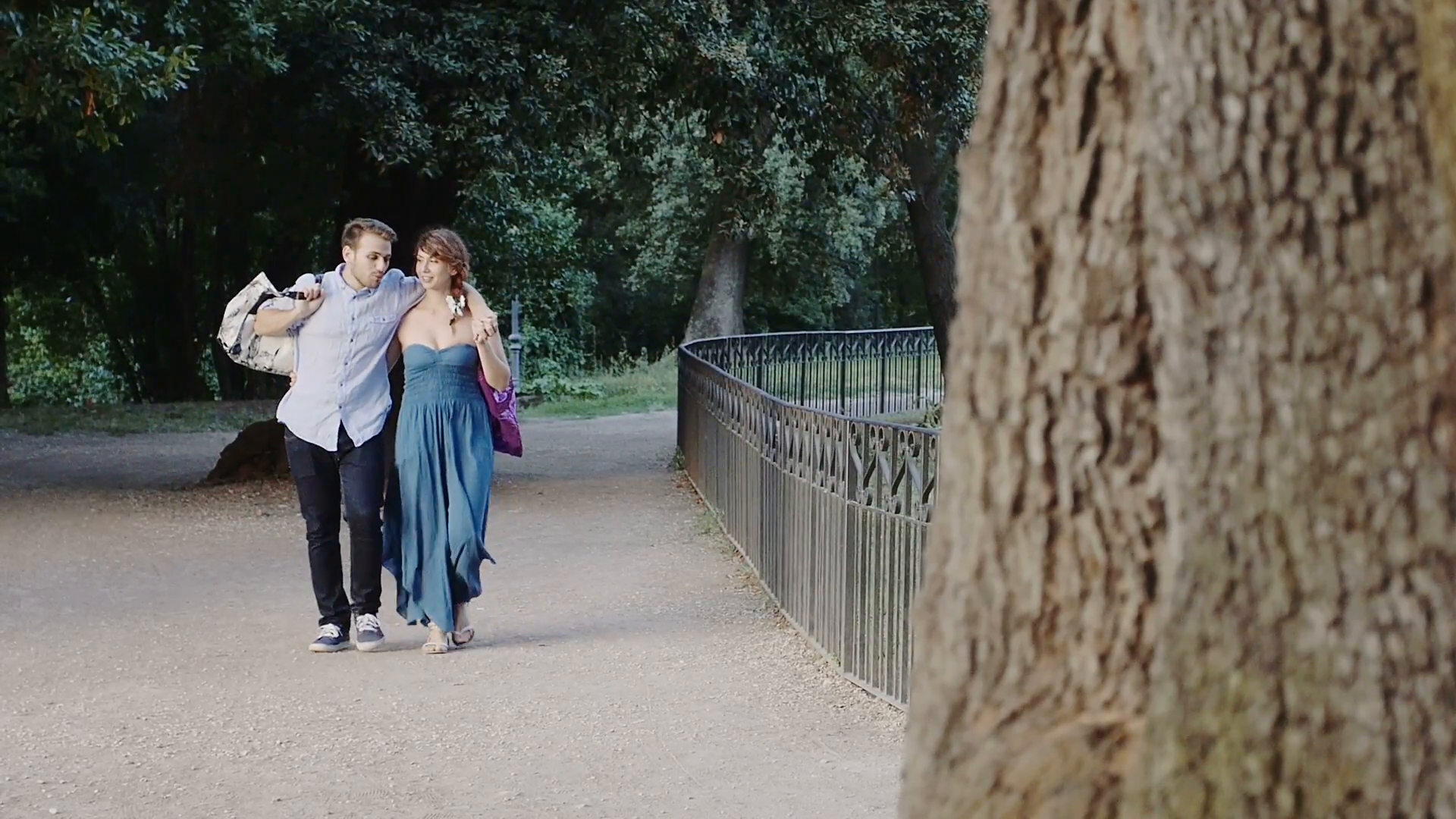 young lovers in the park after shopping: romantic walk in a park of ...