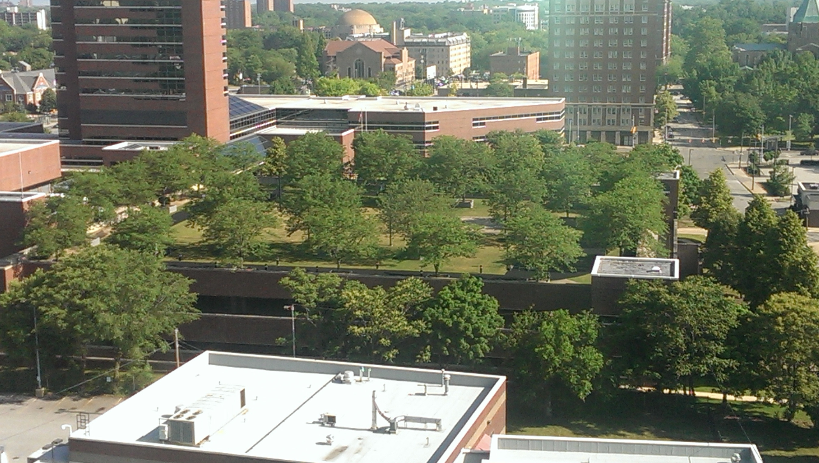 A building with a man made park on its roof with trees ...