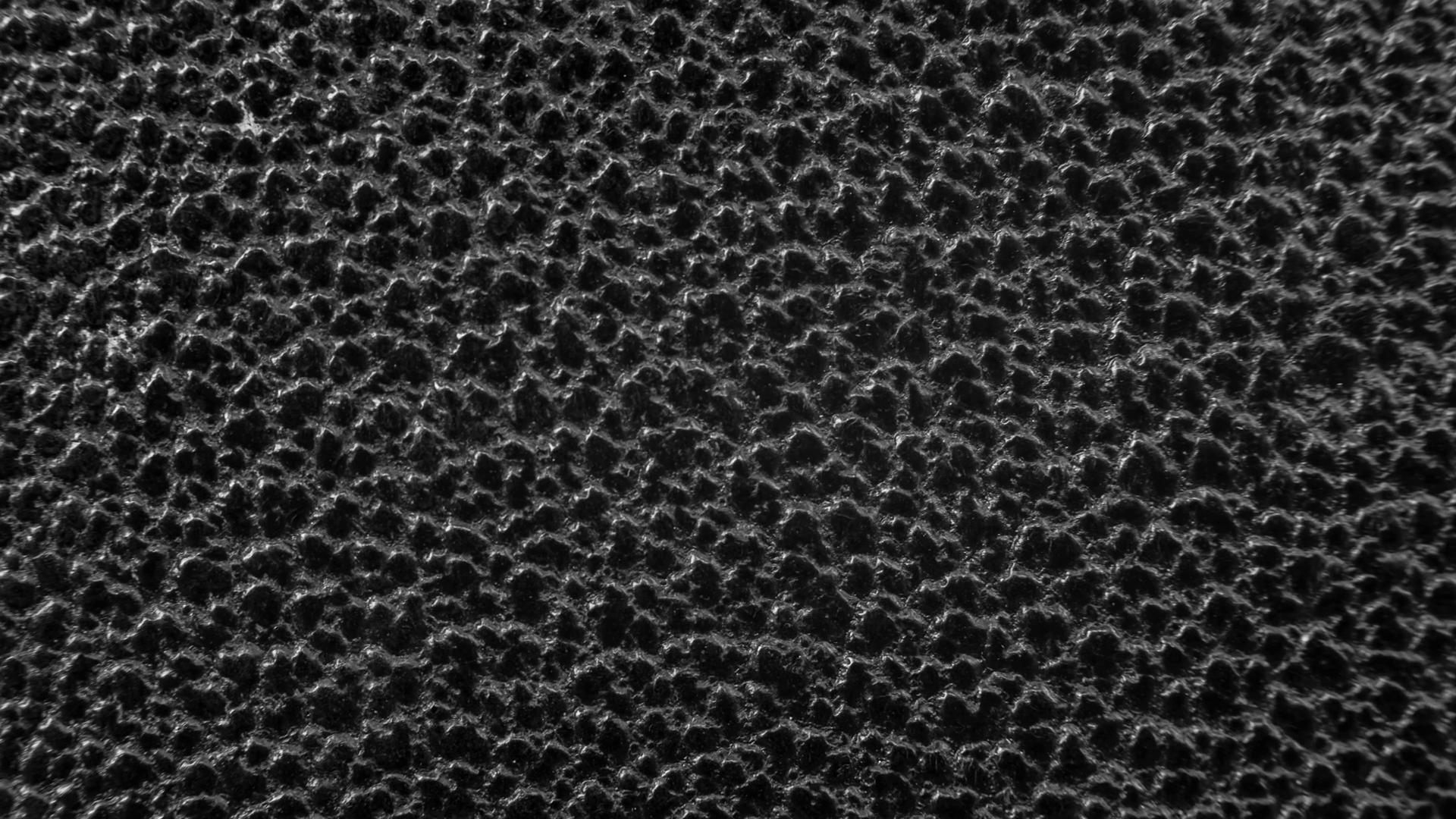 Texture of black rough and coarse plastic surface background zooming ...
