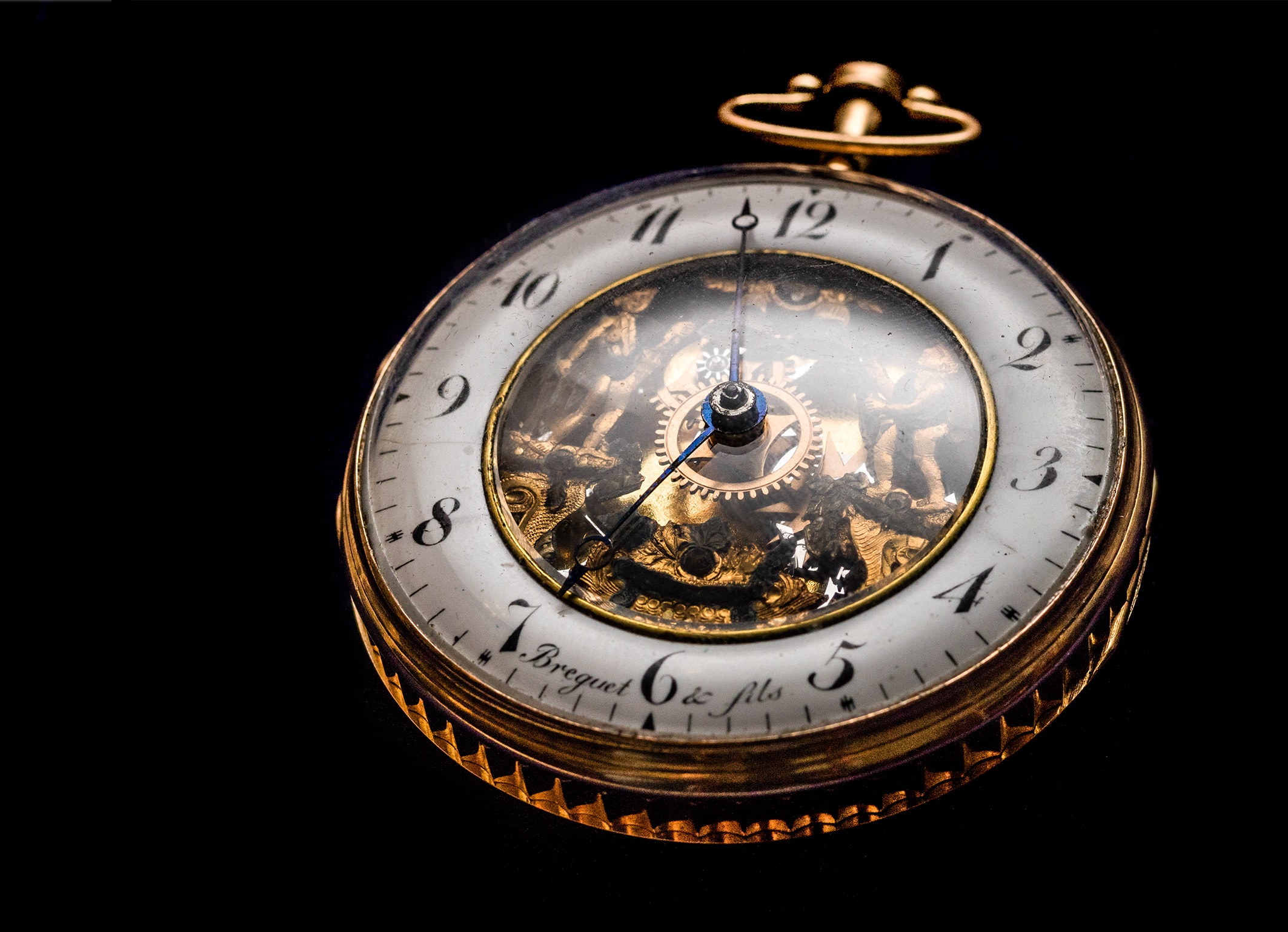 Round gold-colored pocket watch photo