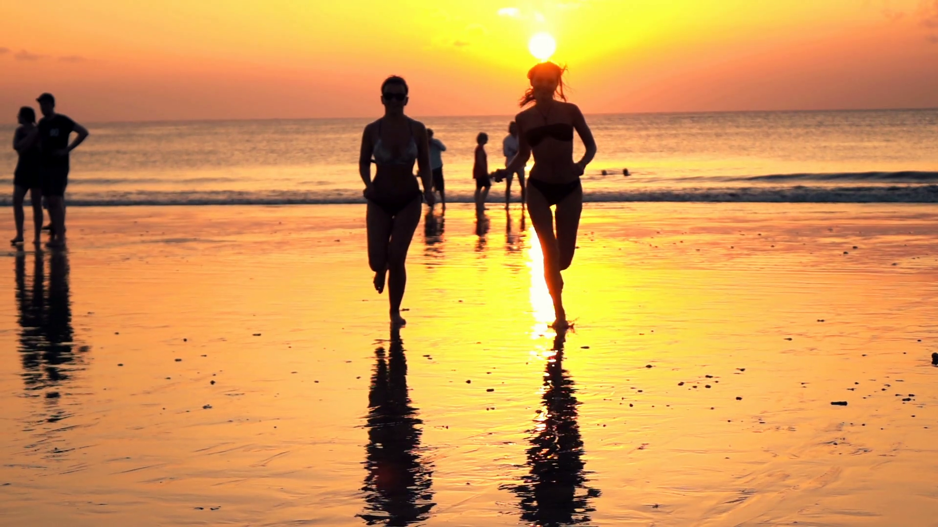 Two girlfriends running on beach, during sunset, super slow motion ...