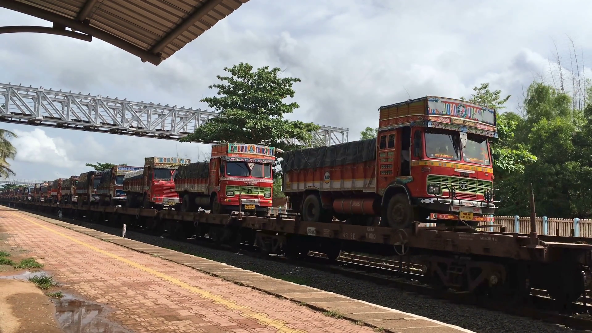 Running train carrying trucks on railway wagon at Kudal Railway ...