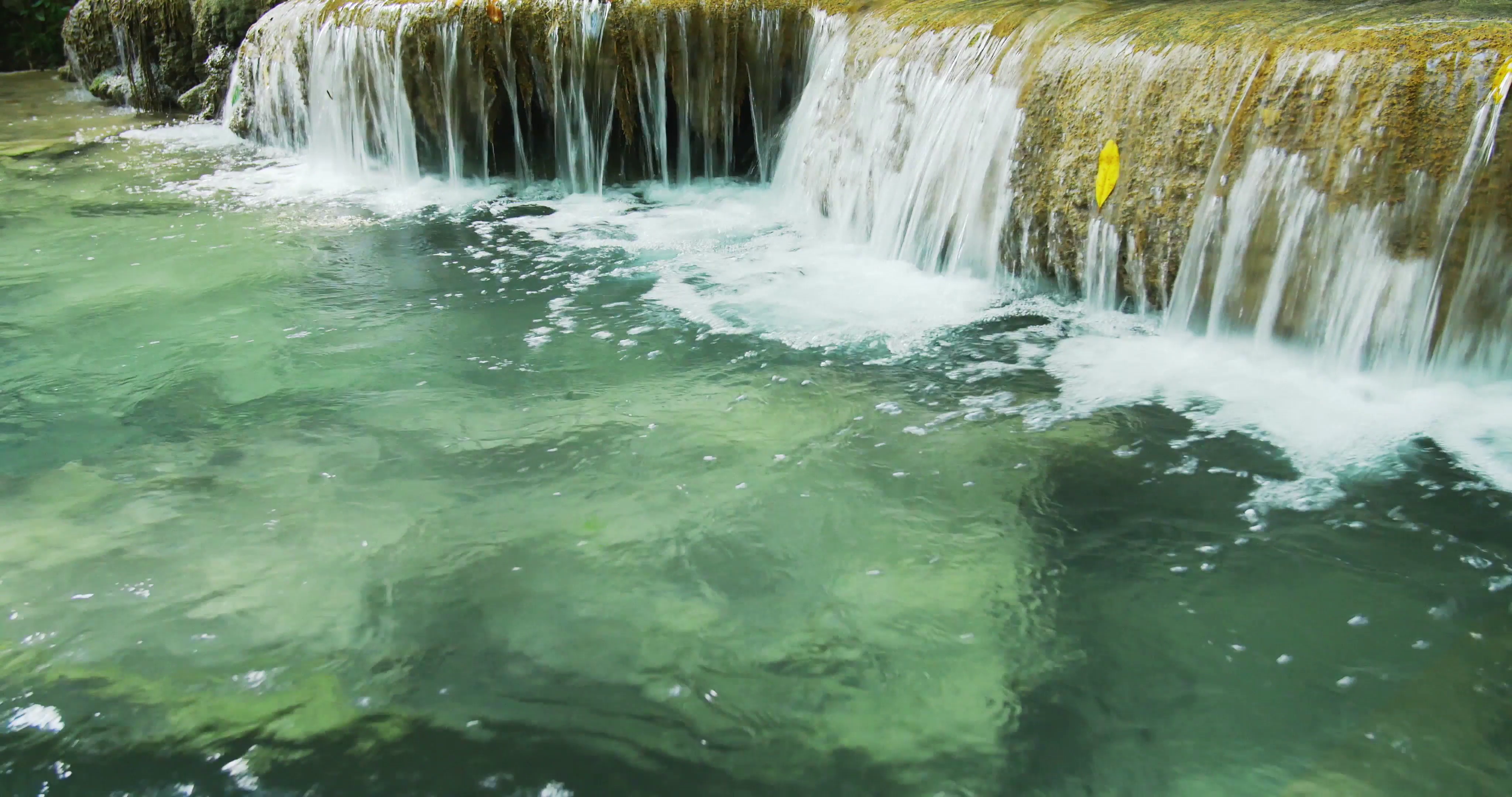 Seamless loop video of running water of small waterfall of mountain ...
