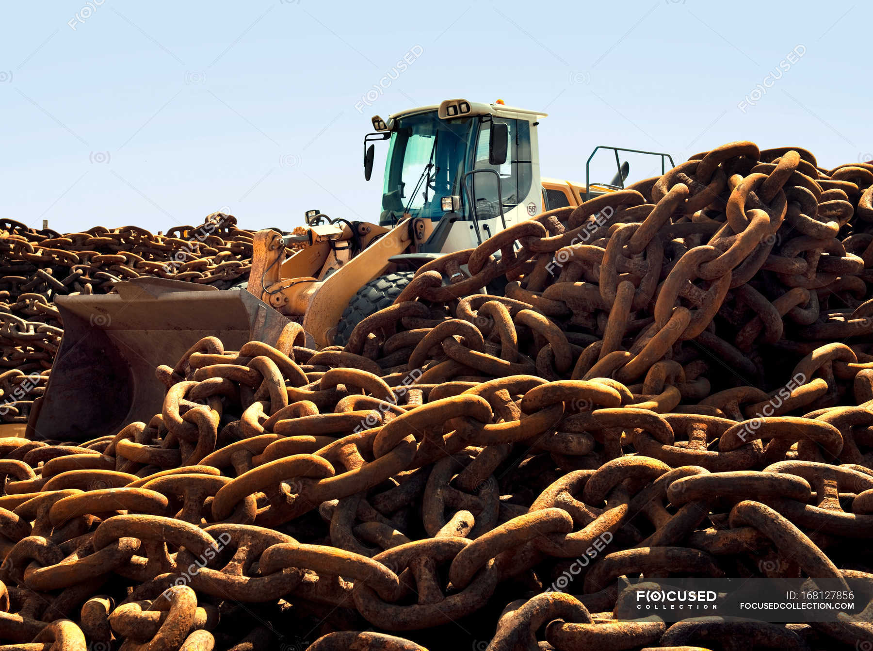 Rusted chains and excavator in scrap yard — Stock Photo | #168127856