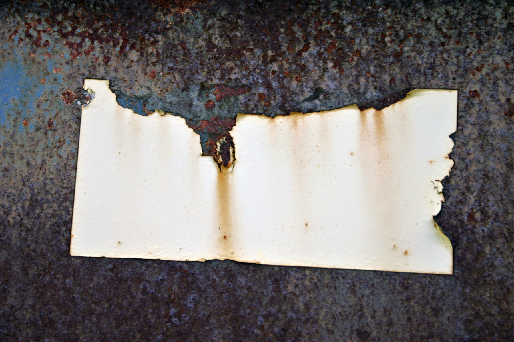 Rusted metal plate with sticker photo