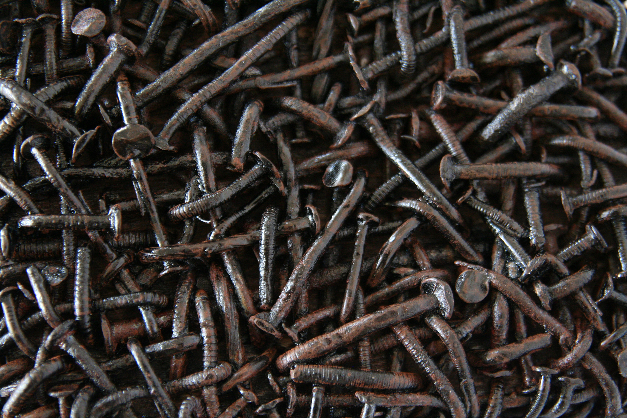 Skein of rusted nails made of nails, wood -