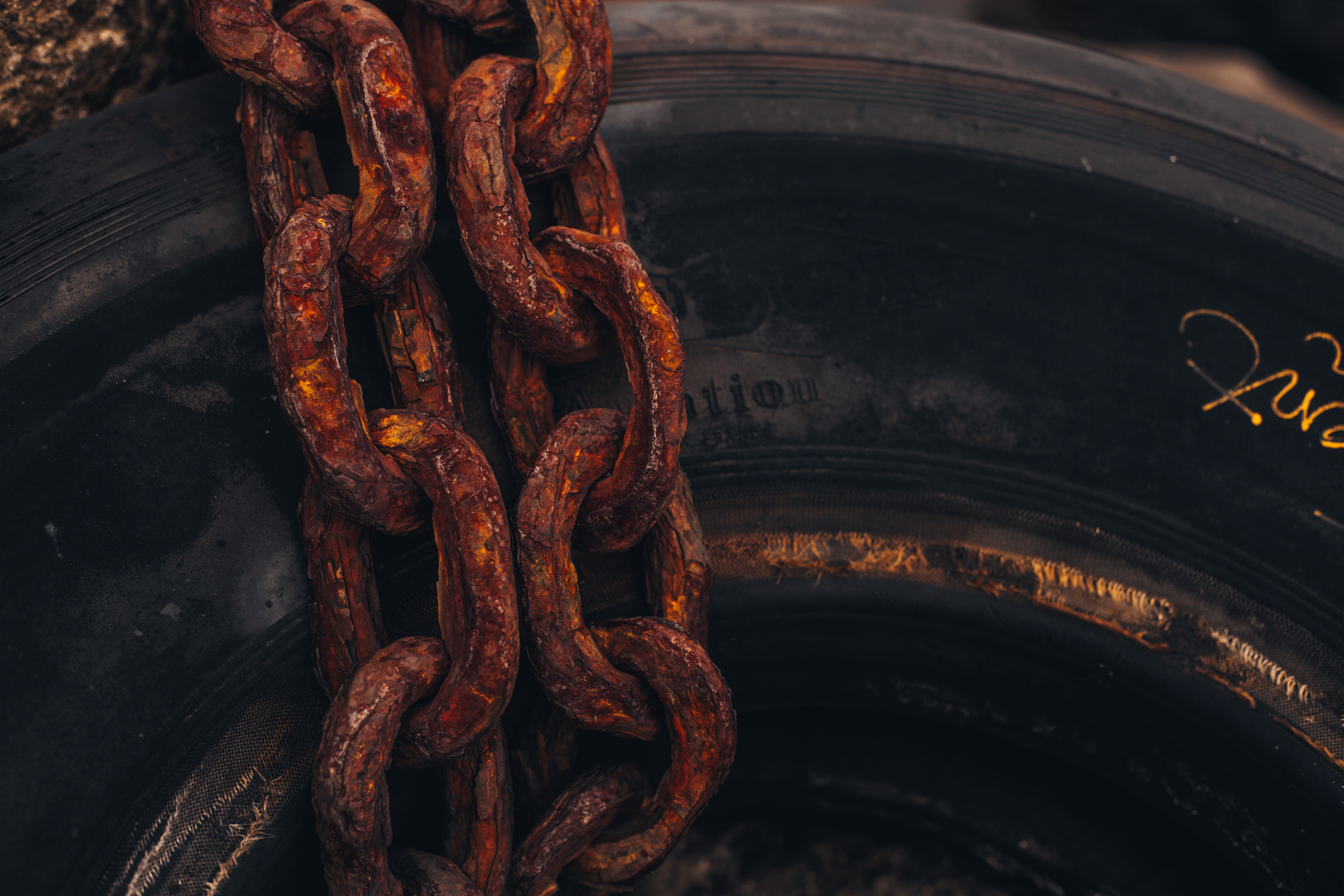 Rusty chain on rubber tire photo