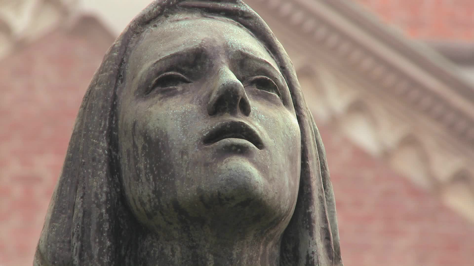 Video: A statue of a woman weeping in a cemetery or church. ~ #11496839