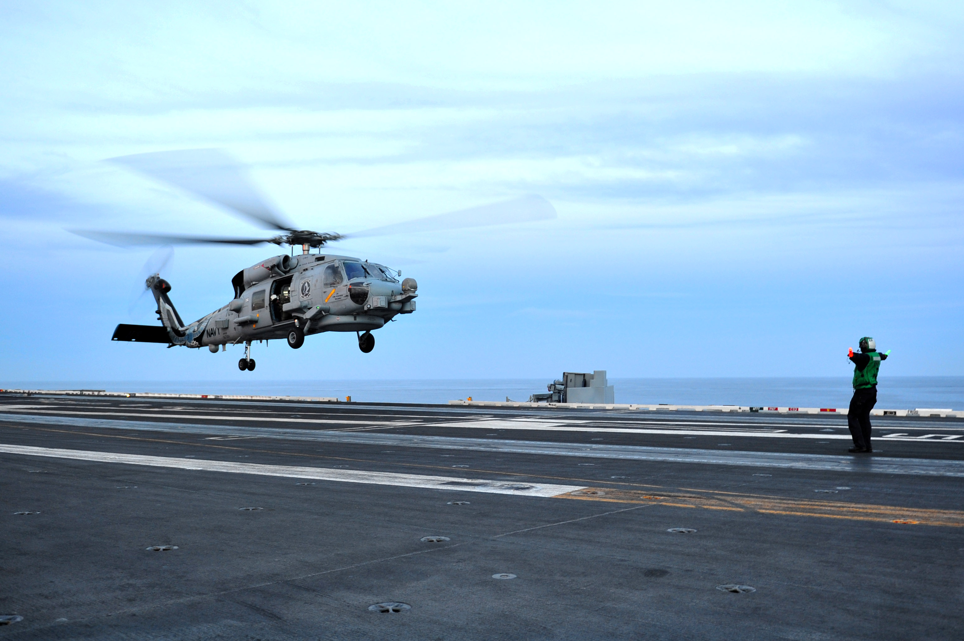 File:A U.S. Sailor directs an MH-60 Seahawk helicopter assigned to ...