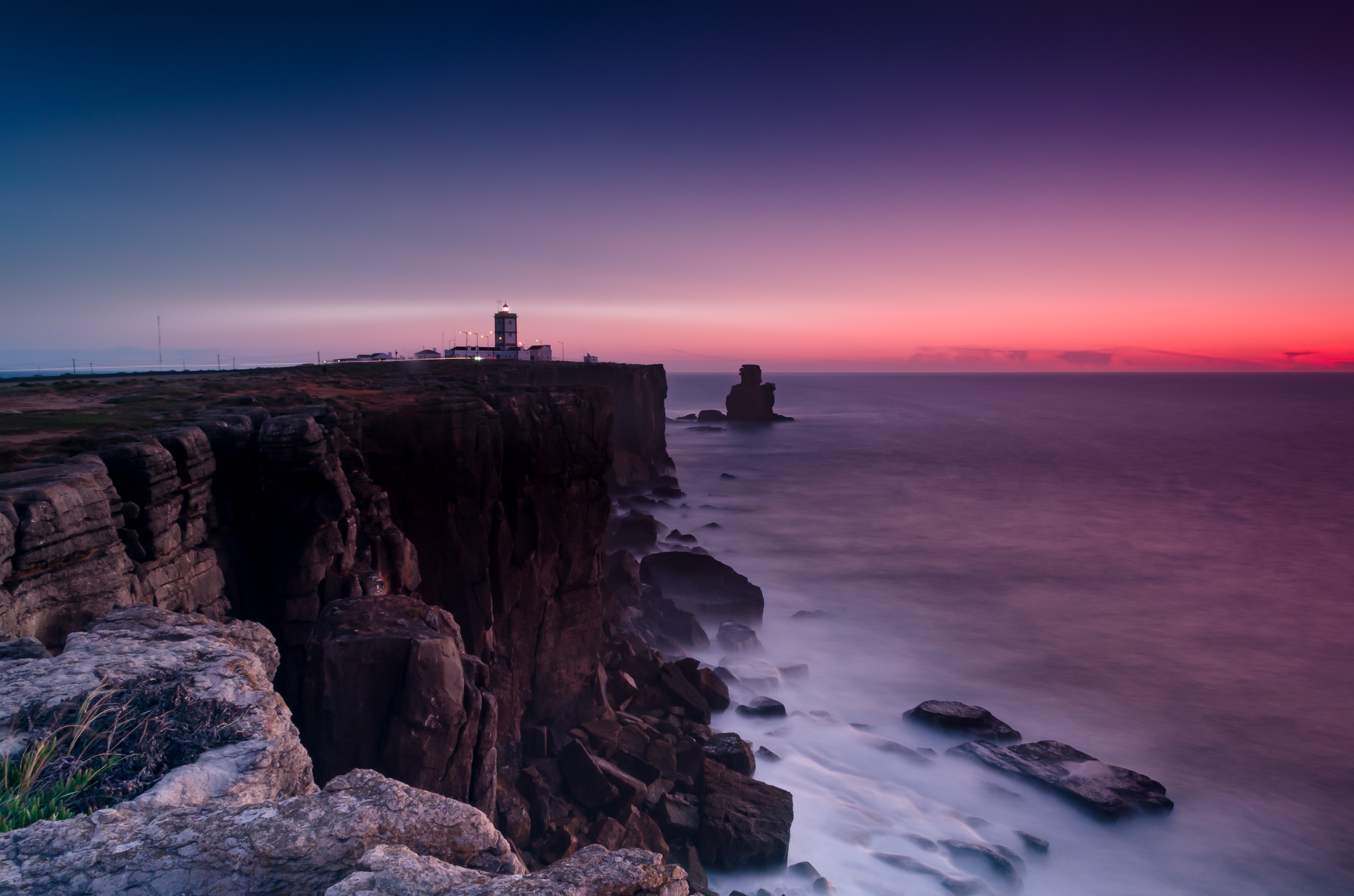 Scenic view of ocean near cliffs during dawn photo