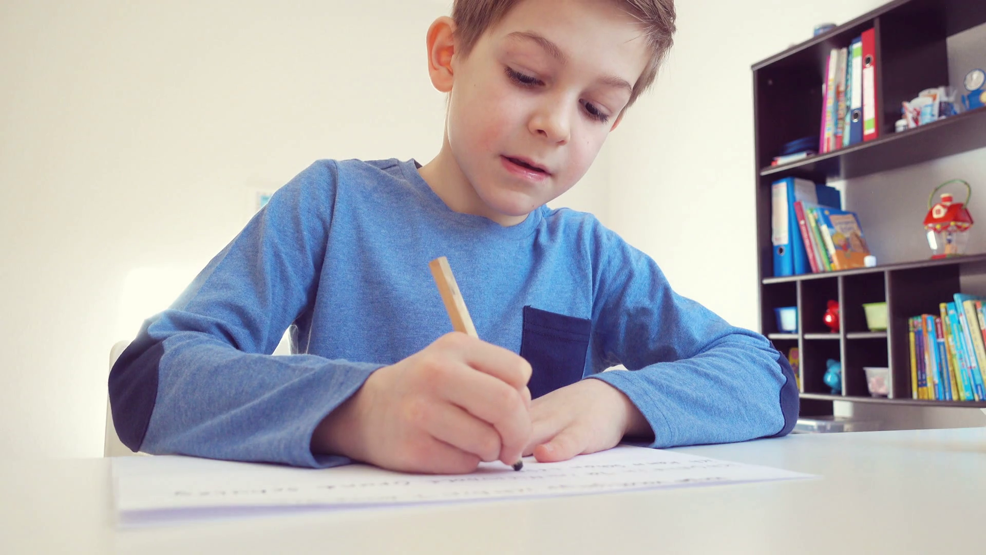 Cute school boy doing homework at desk Stock Video Footage - VideoBlocks