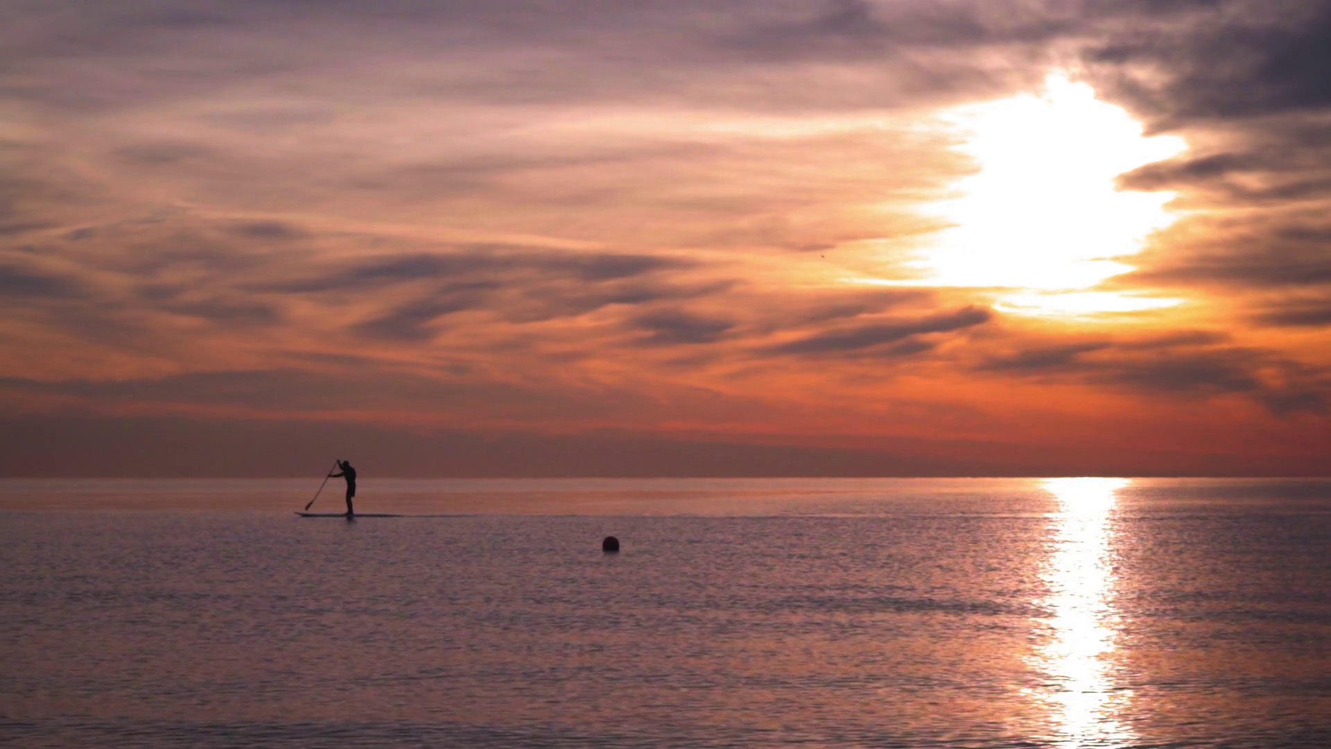 Silhouette of man on surfing board at sea at sunset. Sunset sea. Sun ...