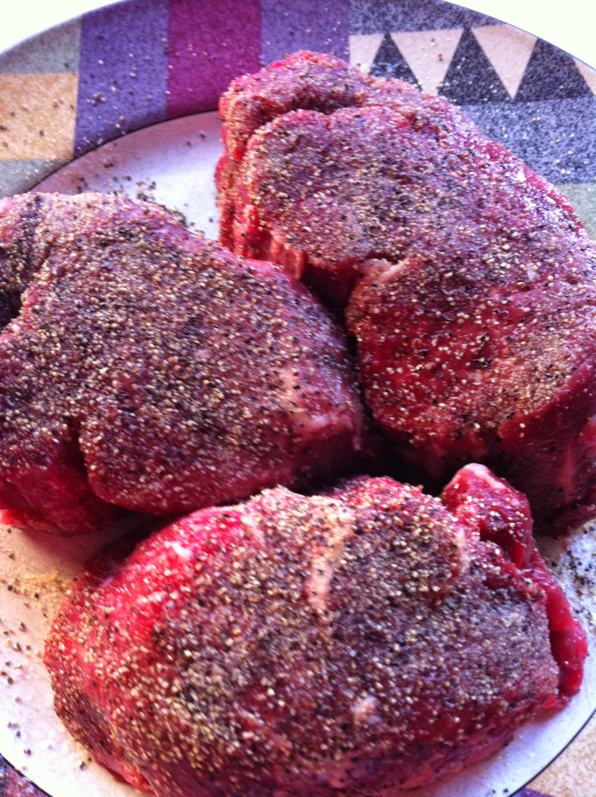 Seasoned raw steaks photo
