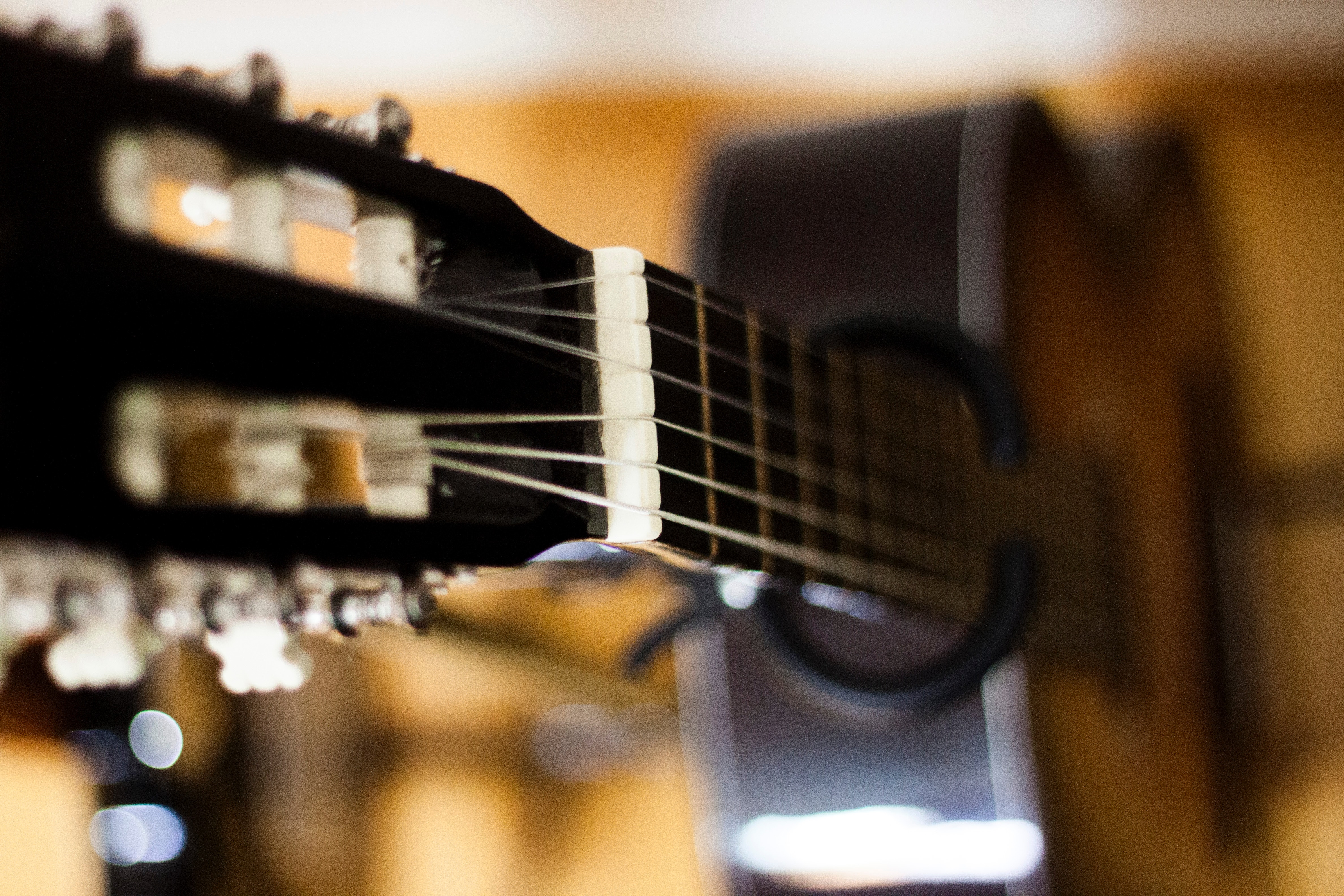 Selective focus photo of black classical guitar