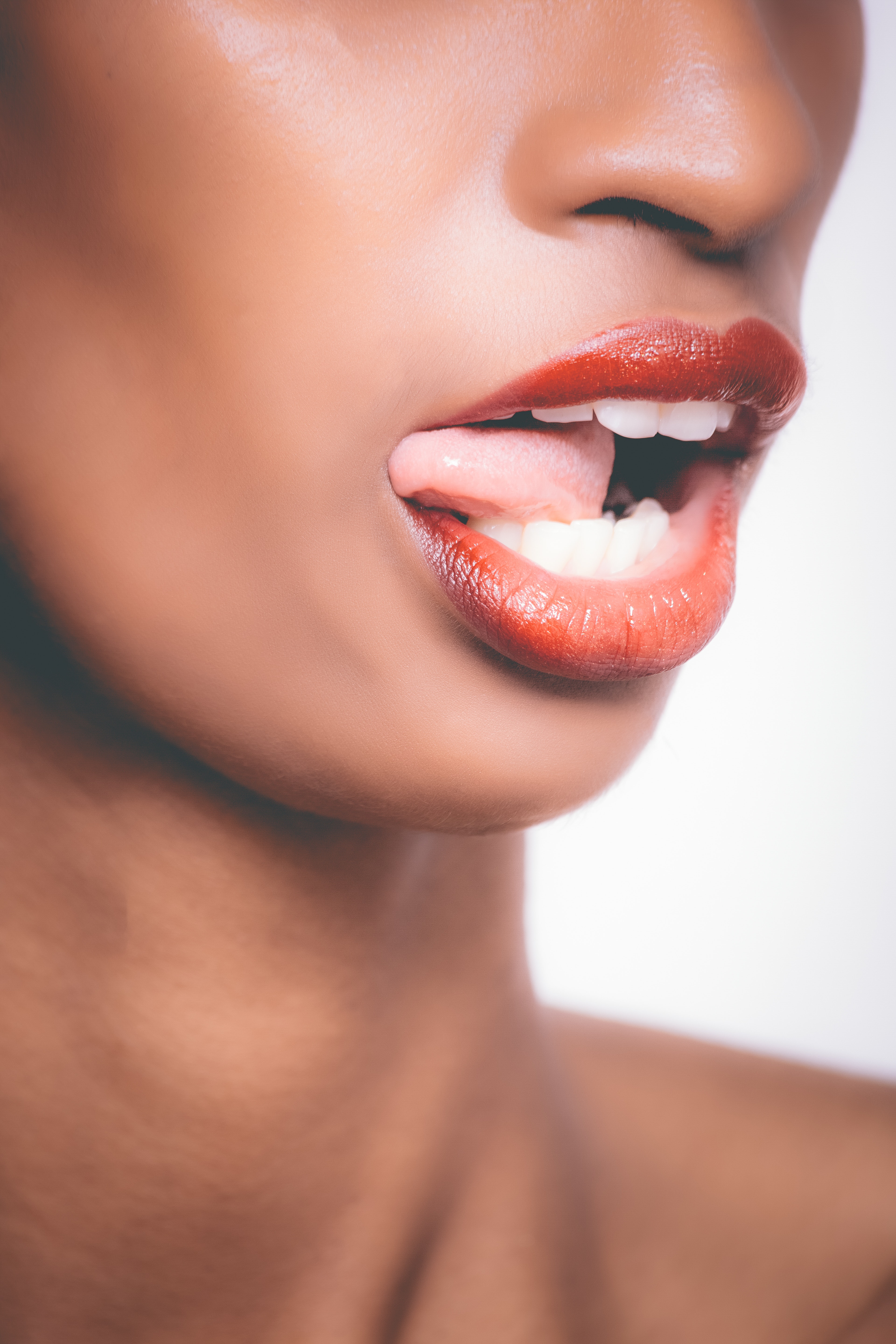 Selective focus photograph of woman sticking her tongue out