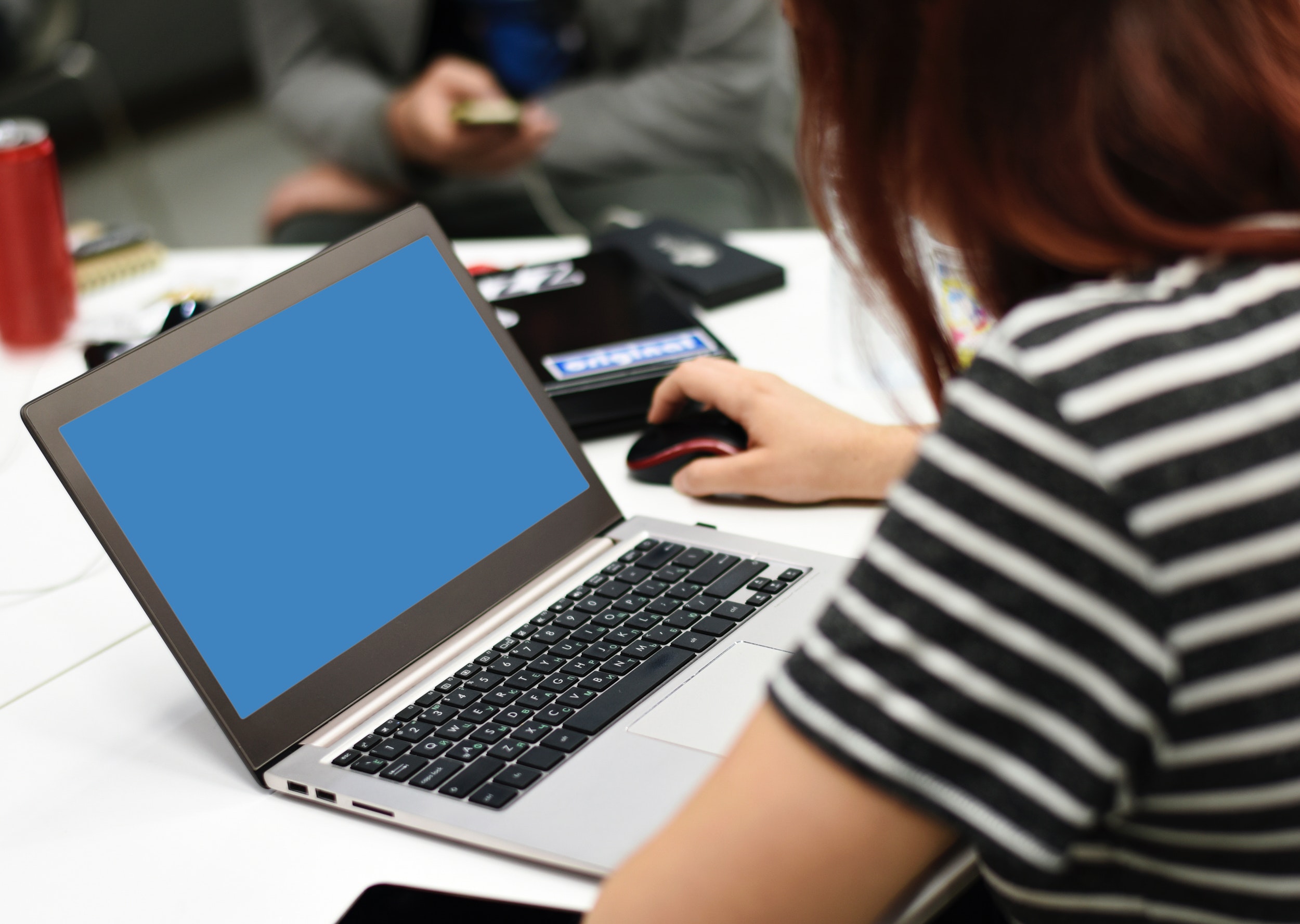 Selective focus photography of a woman using laptop