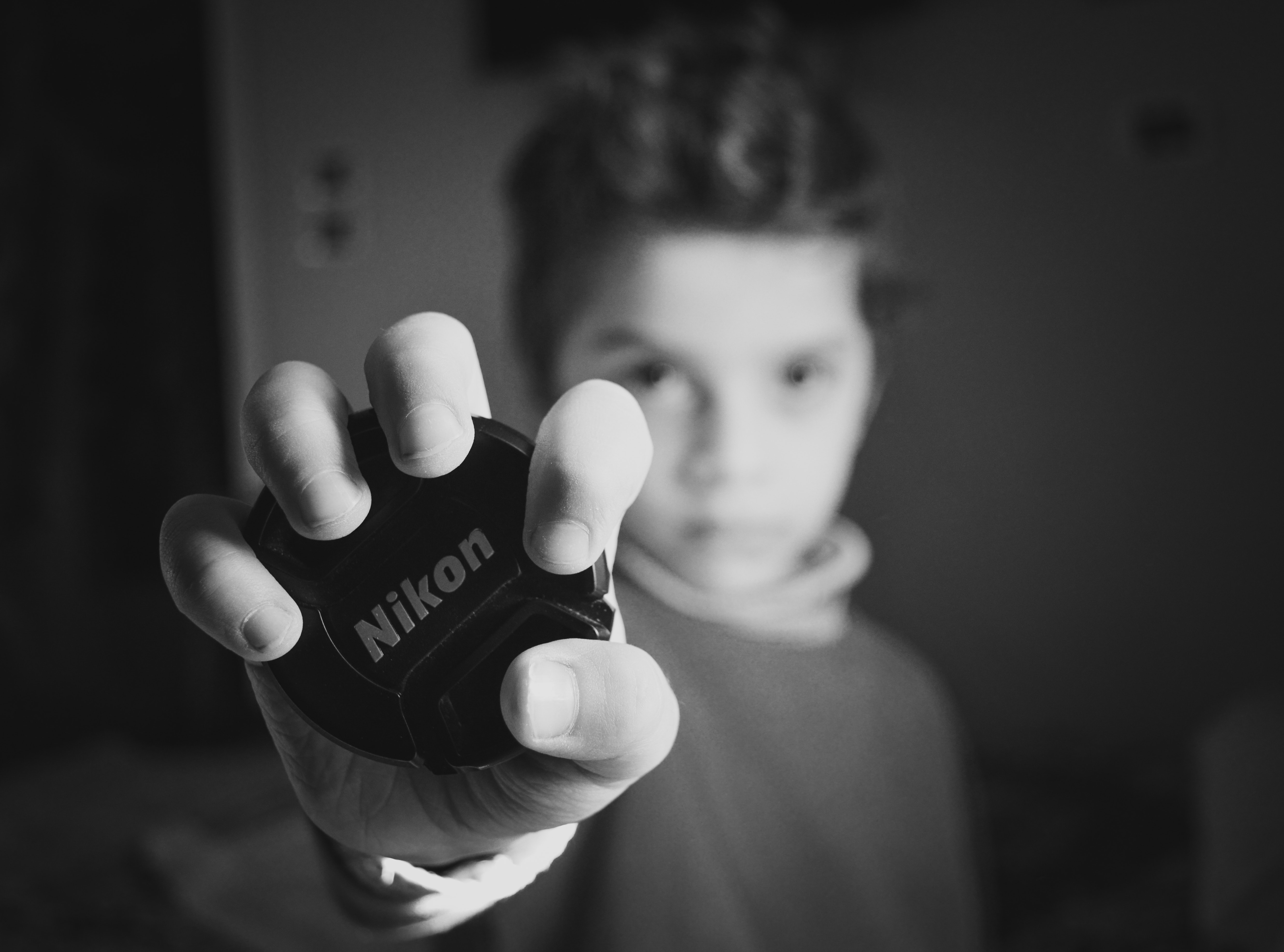 Selective Focus Photography of Boy Holding Nikon Lens Cover, Black, Kid, White, Portrait, HQ Photo