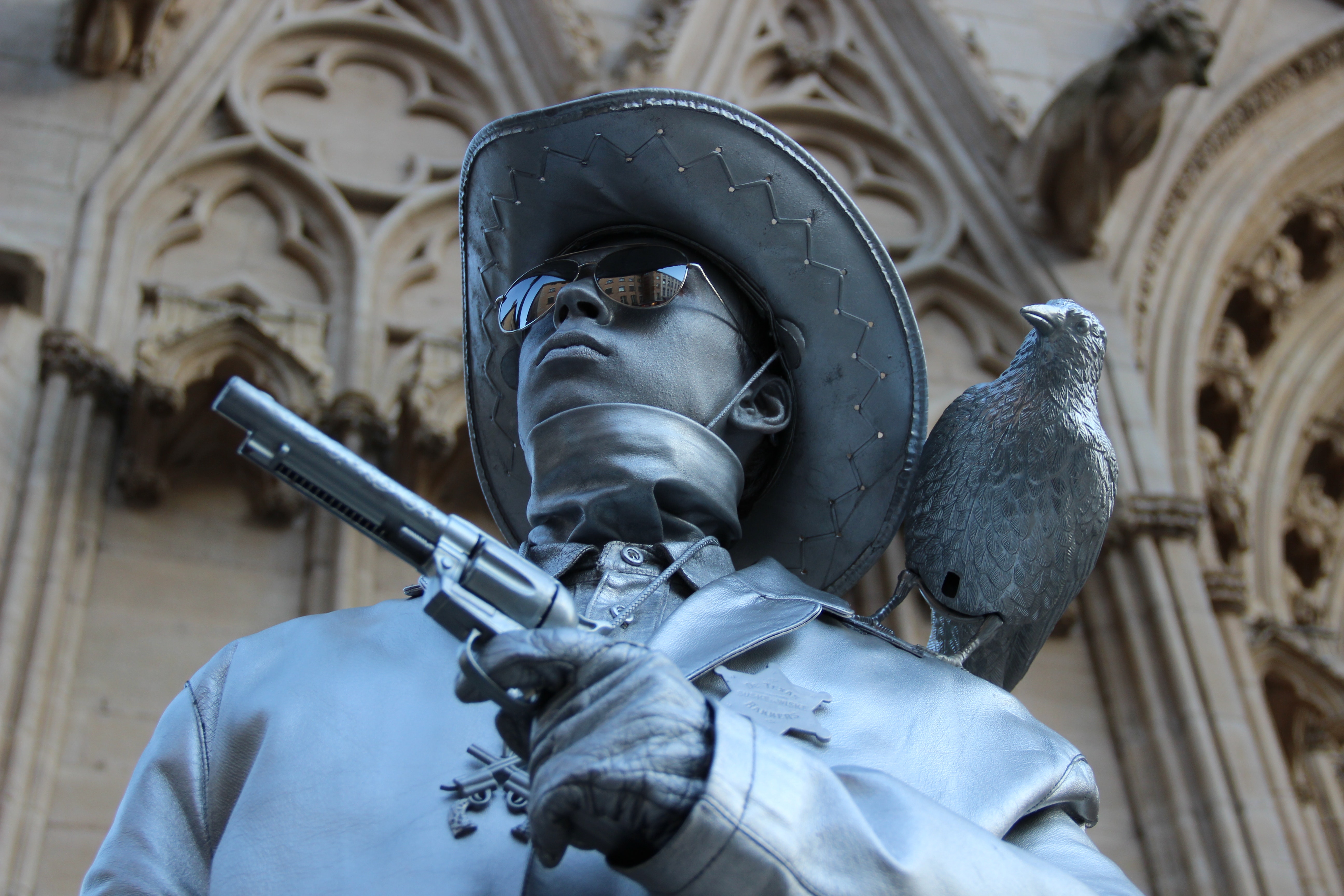 Selective focus photography of cowboy holding revolver pistol statue