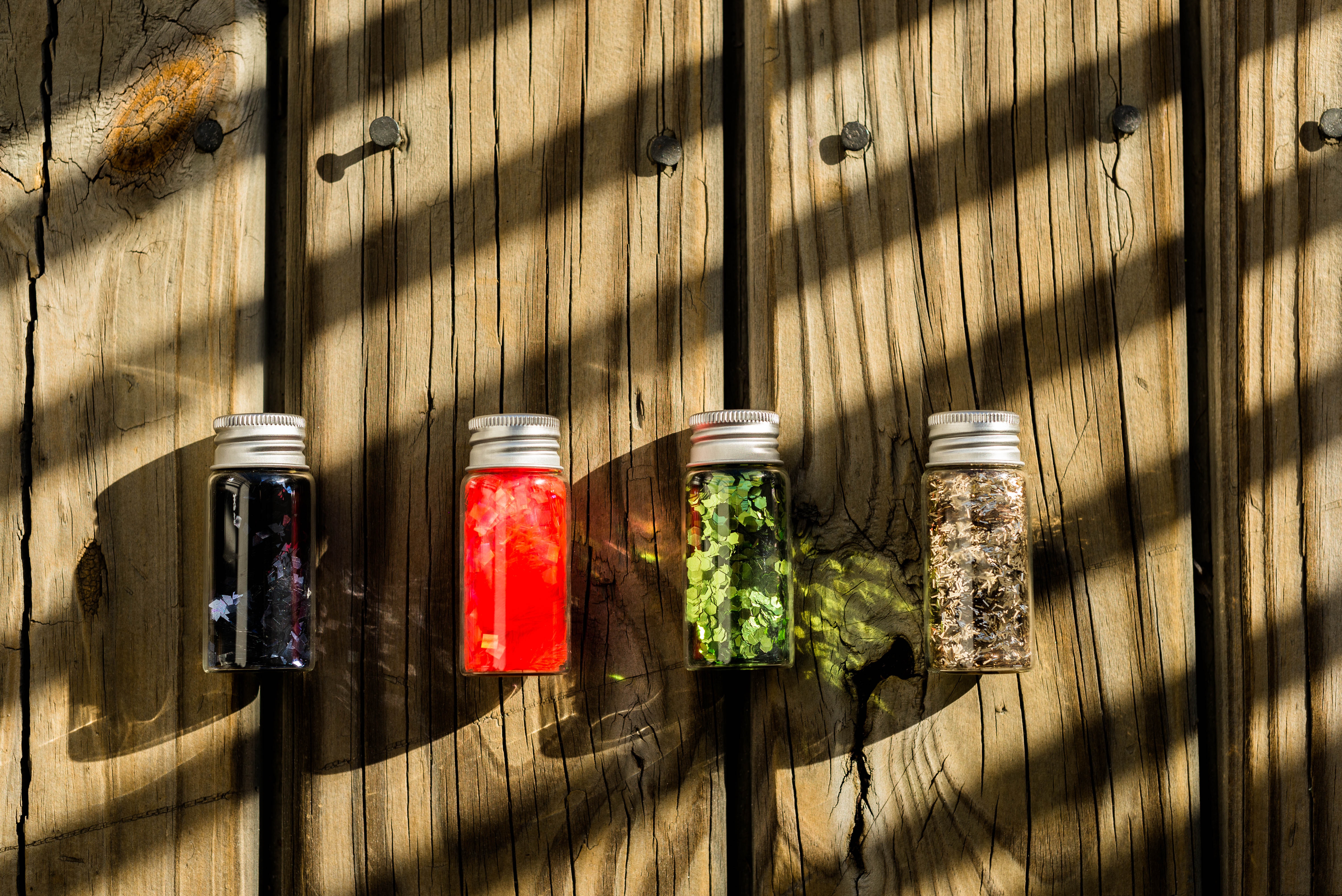 Several assorted-color glass bottles on table photo