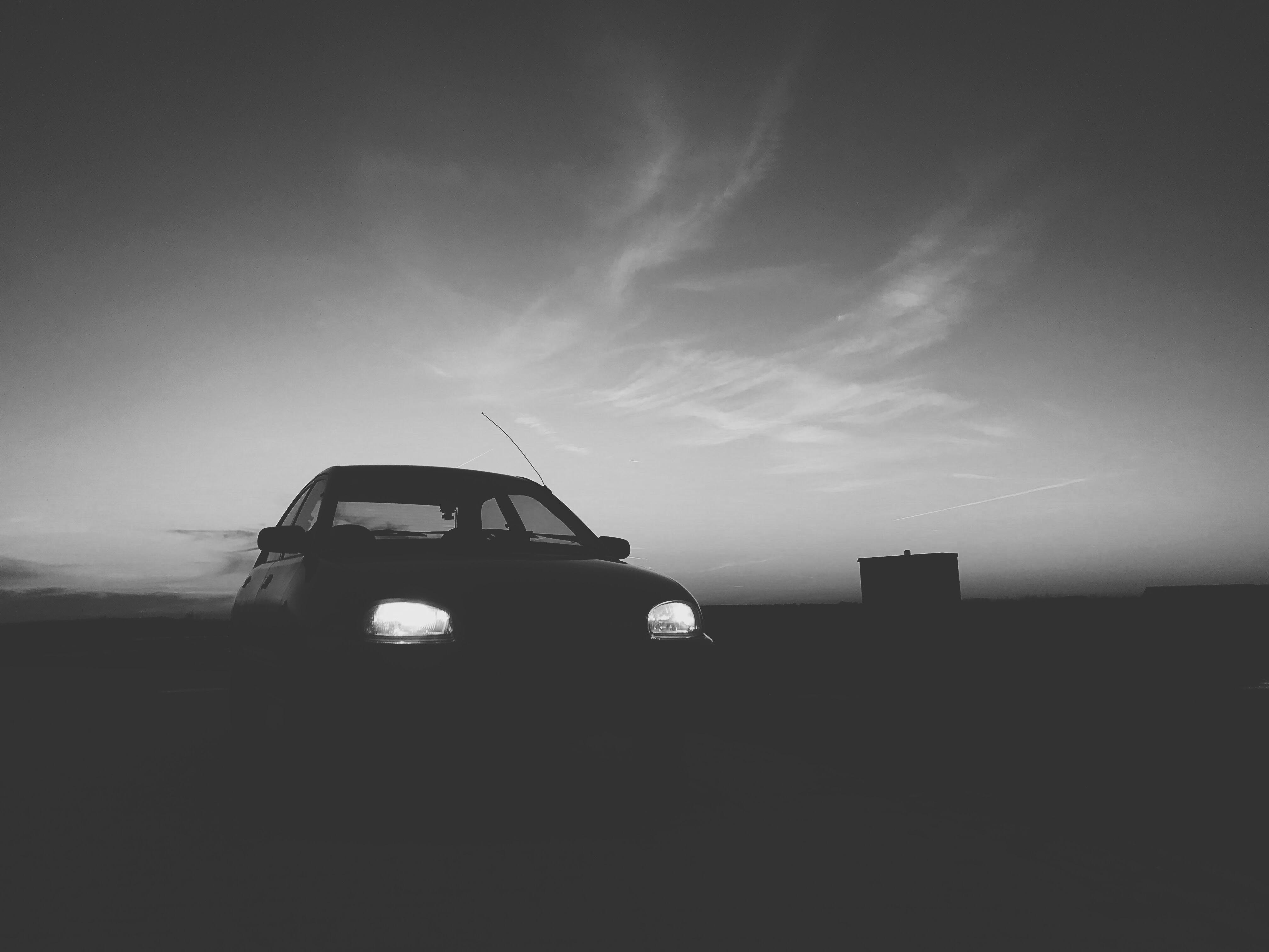 Silhouette of car with turned on light photo