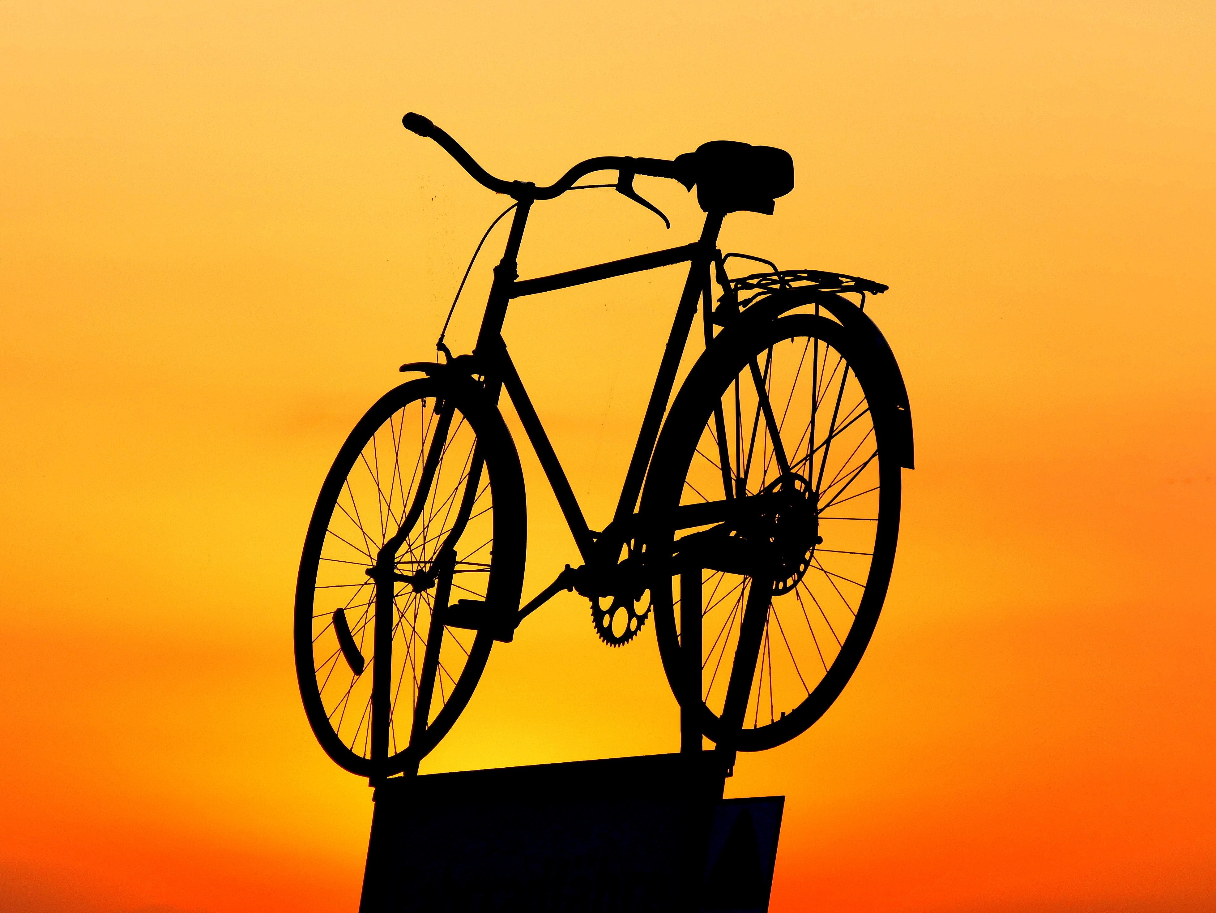 Silhouette of cruiser bike during sunset photo