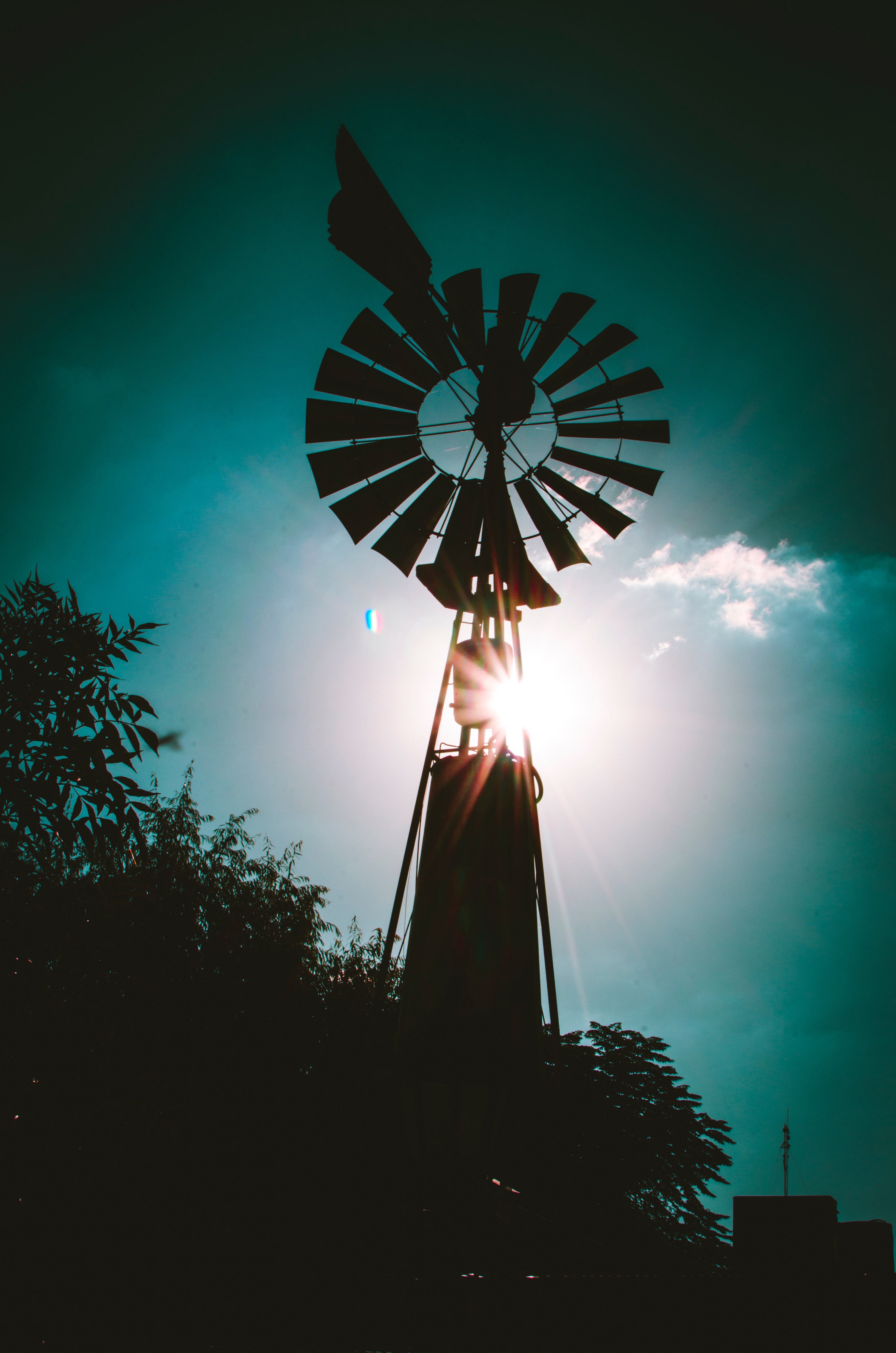 Silhouette of farm windmill photo