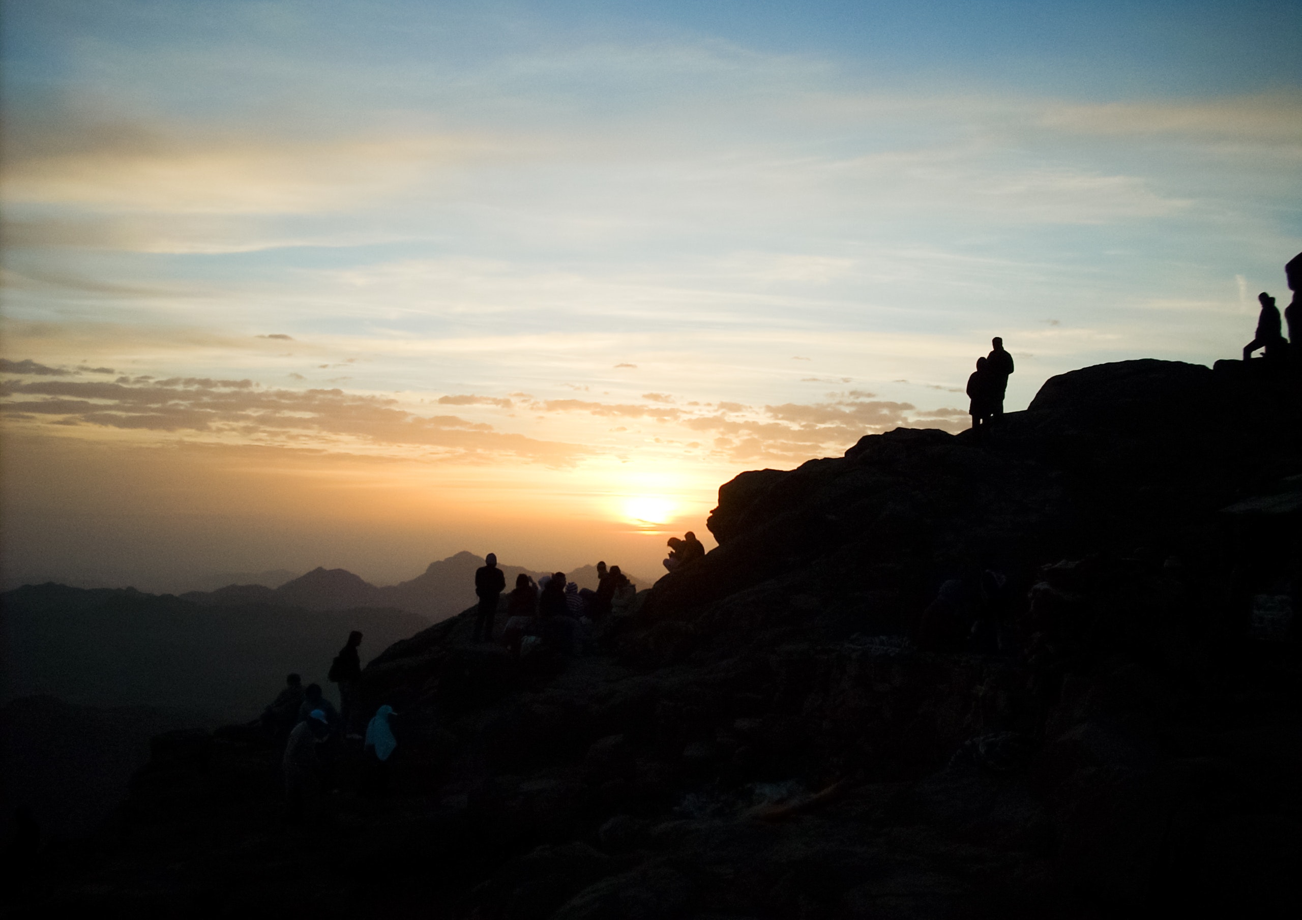 Silhouette of group of person hiking on the mountain photo