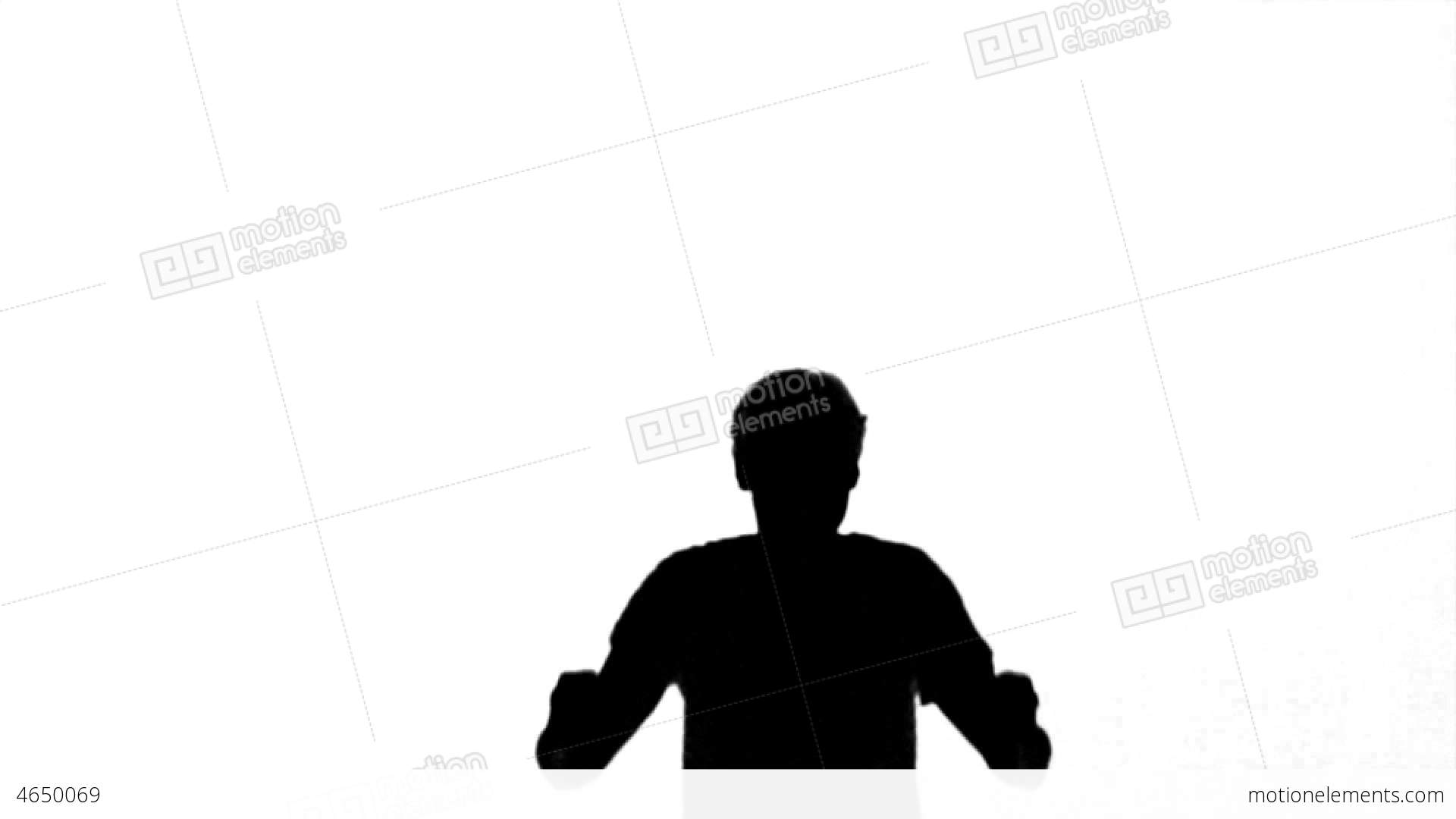 Silhouette Of A Man Jumping With Raised Arms On Wh Stock video ...
