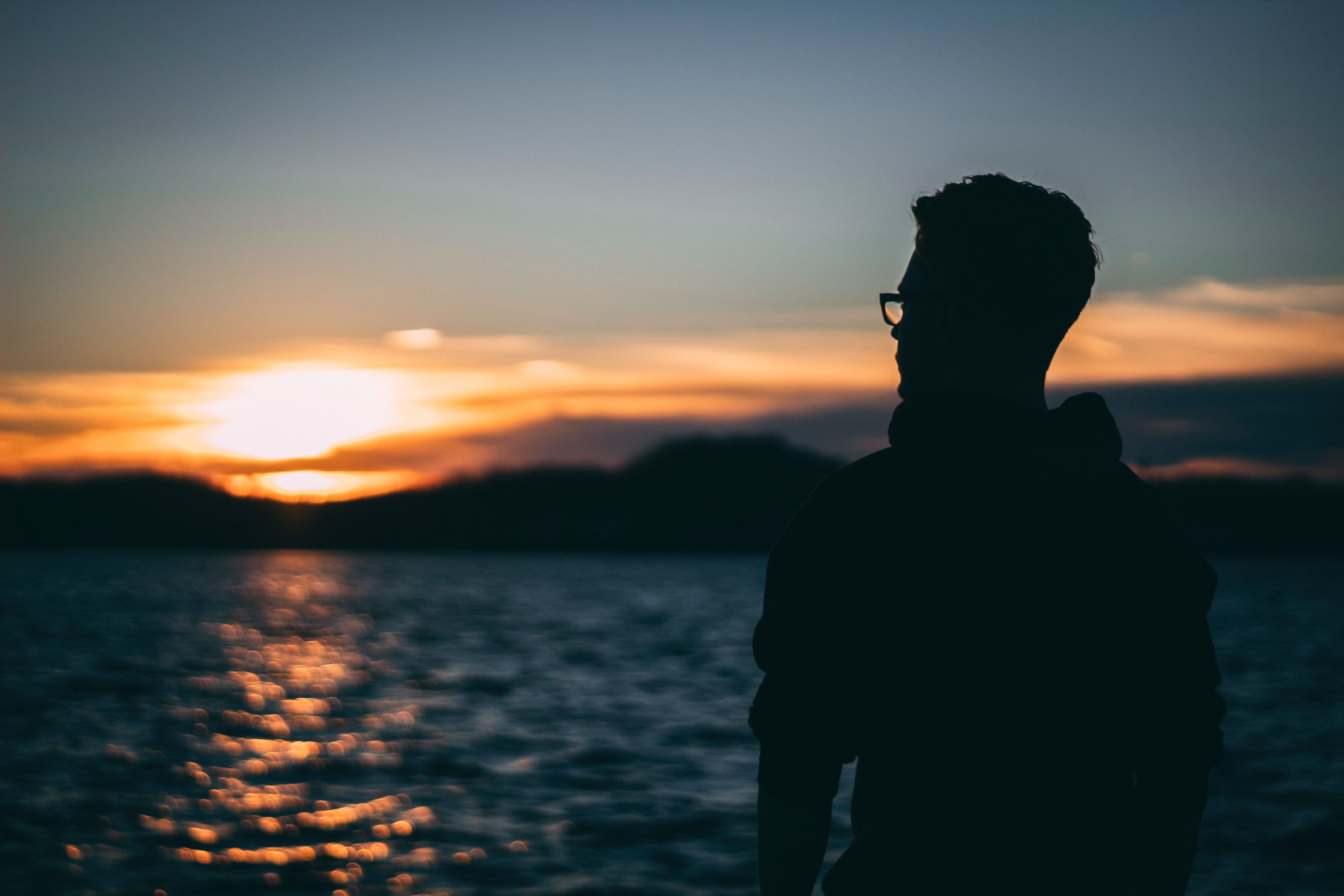 Silhouette of man during sunrise photo