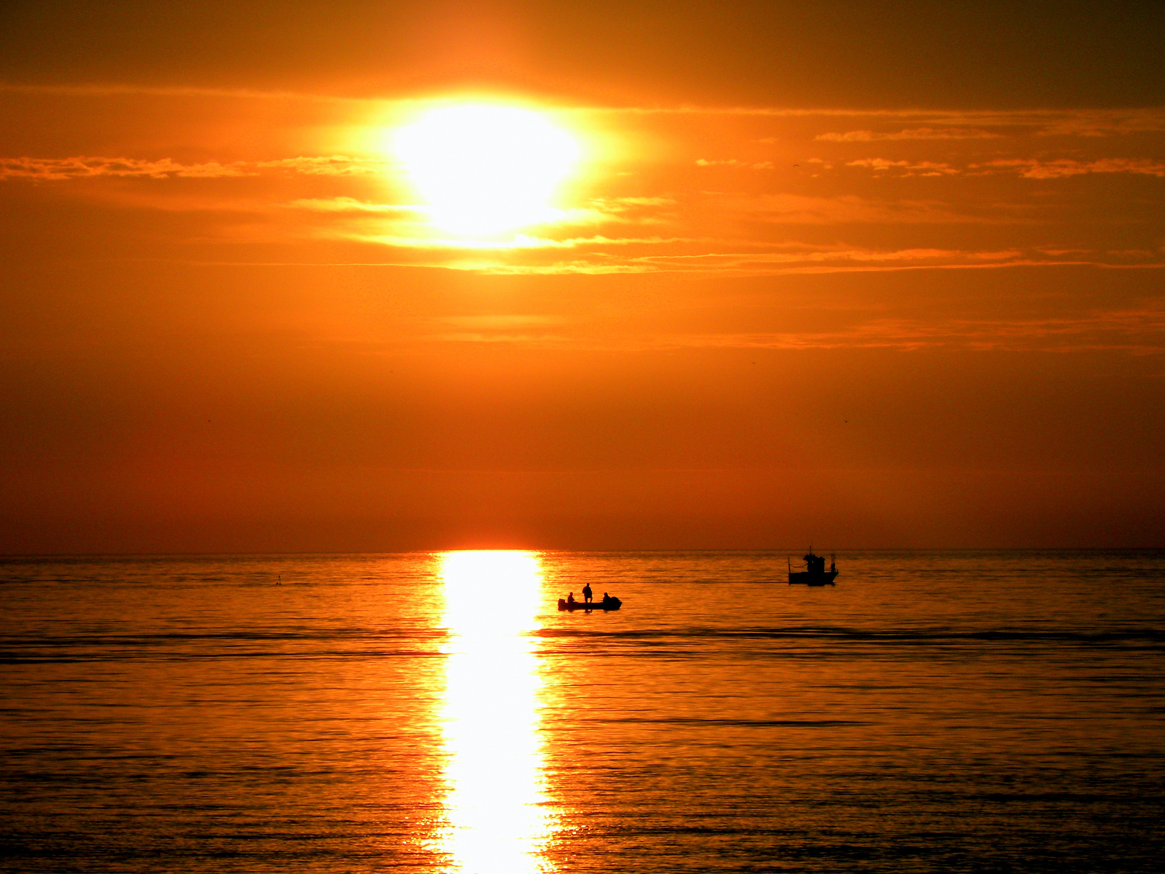 Silhouette of people on boat during golden hours photo