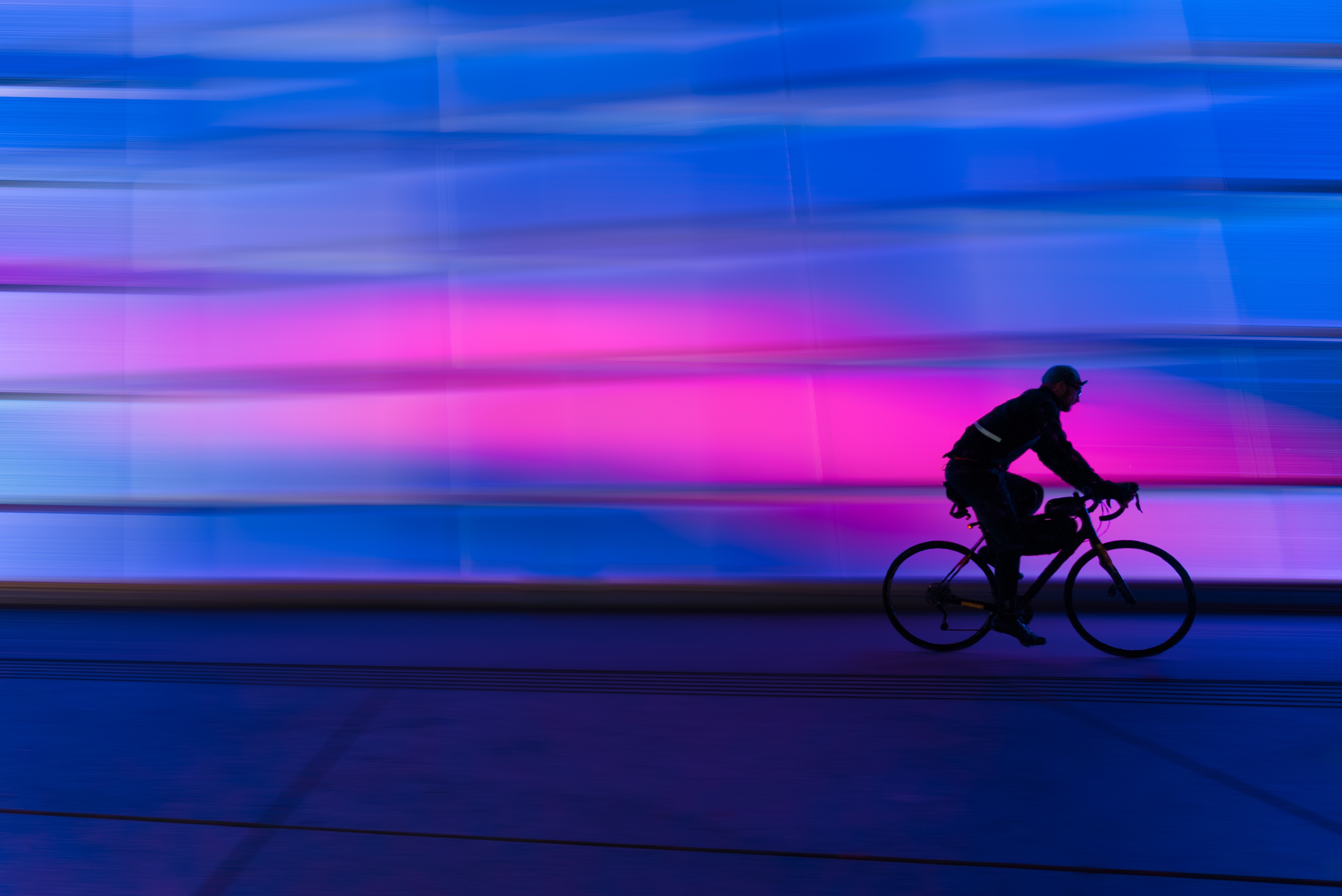 Silhouette of person riding on commuter bike photo
