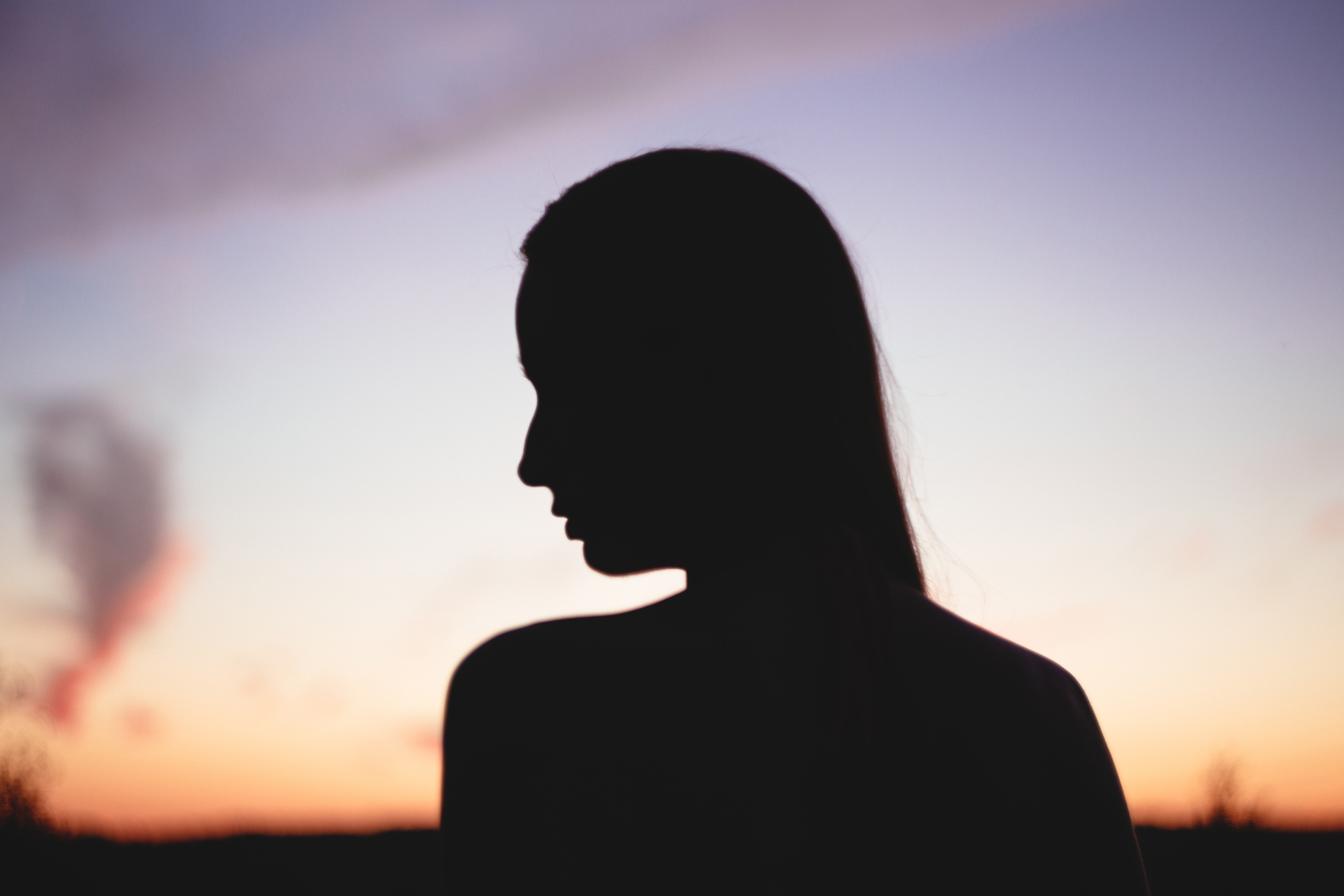 Silhouette of woman during sunset photo