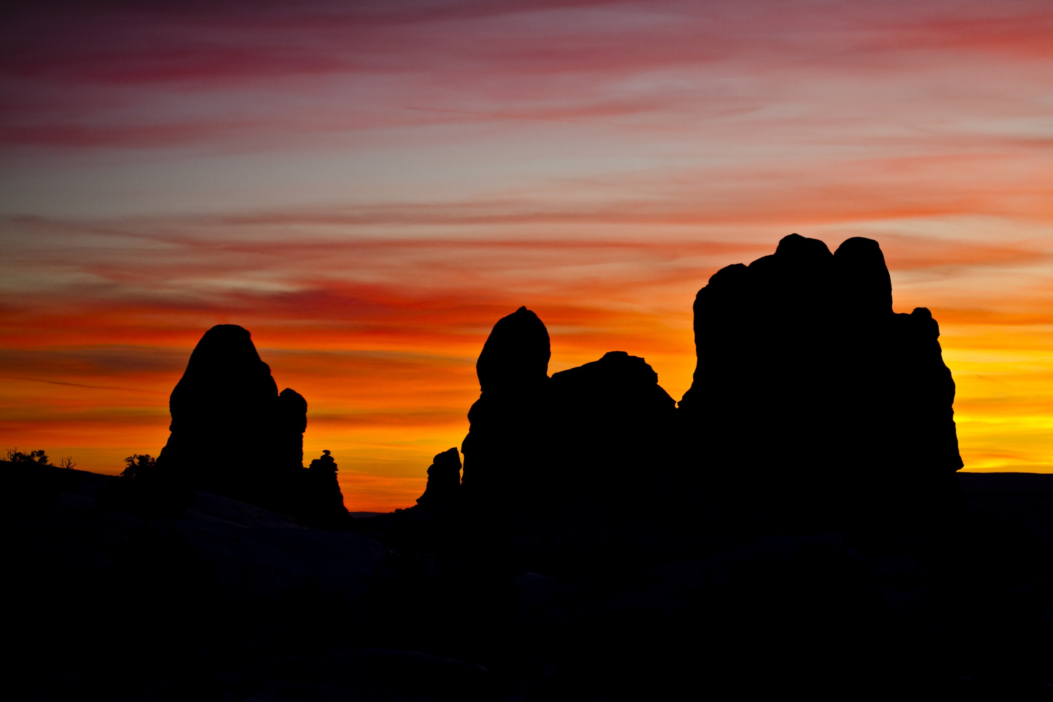 Silhouettes of rock formation during sunset photo