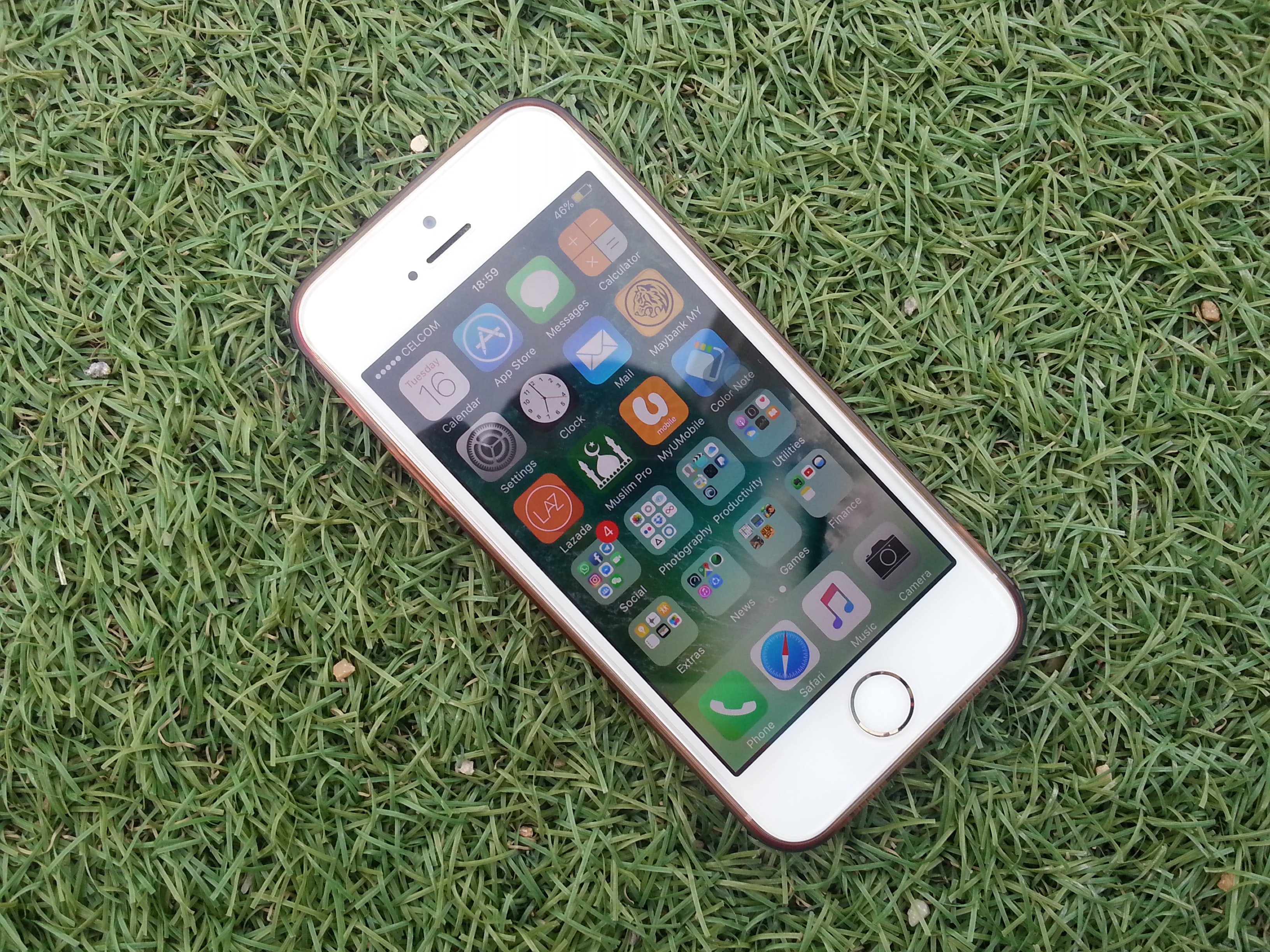 Silver iphone on a green grass photo