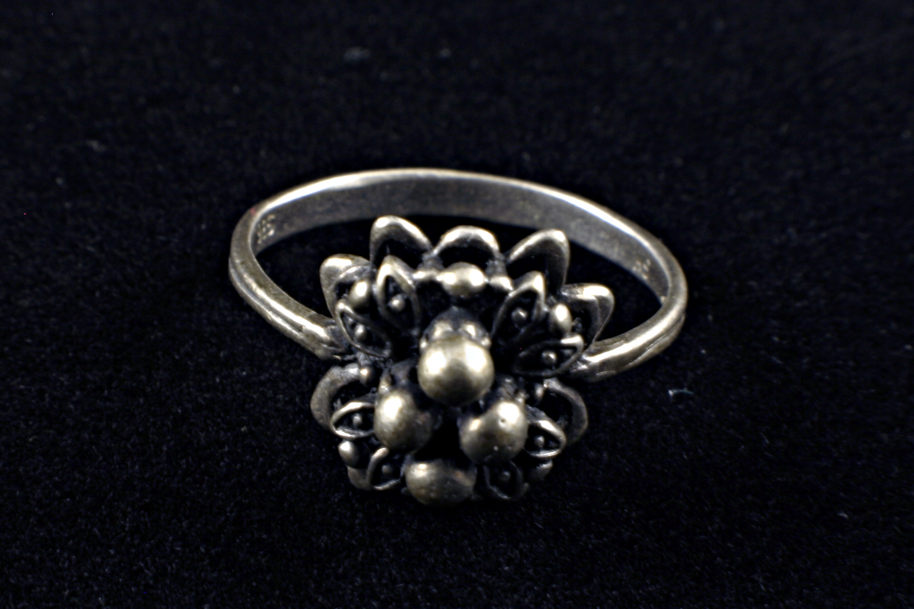 Silver ring with flower decoration photo