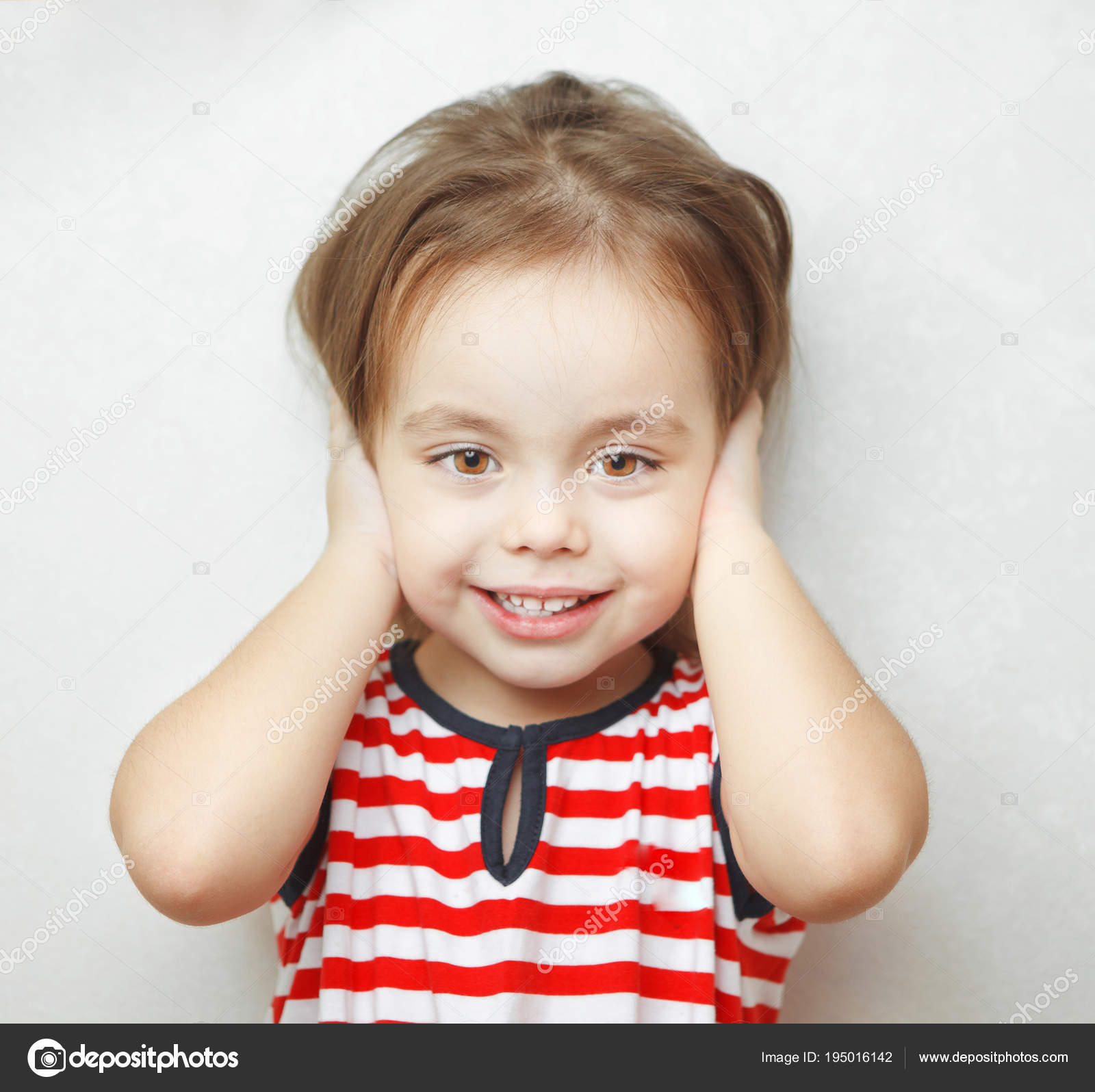 Little girl with sincere smile covers her ears — Stock Photo © il21 ...