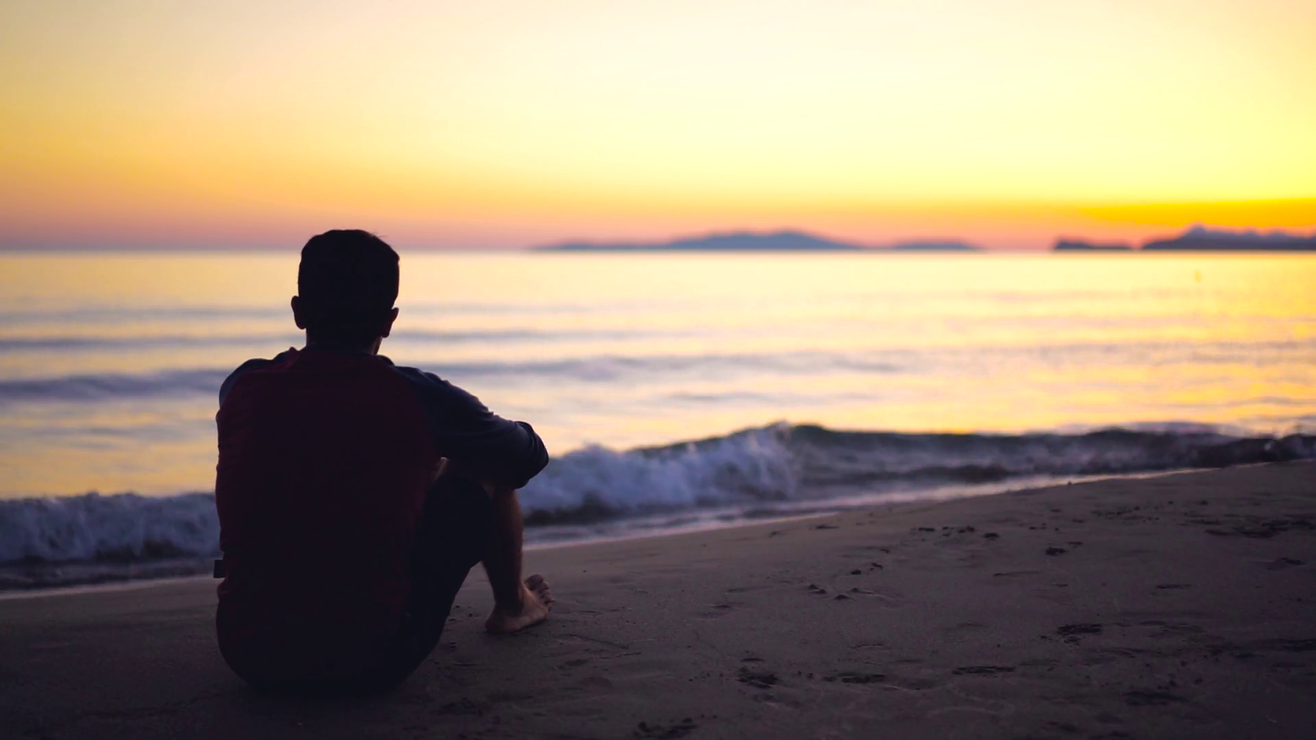 Man sitting alone on beach sunset slow motion Stock Video Footage ...