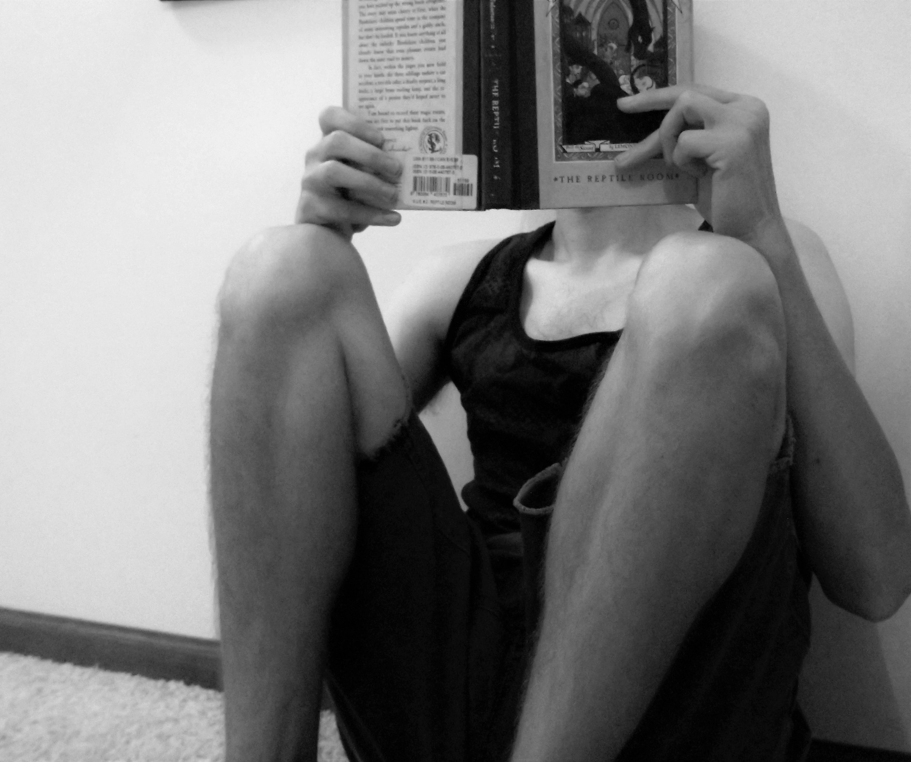 Sitting knees to chest reading photo