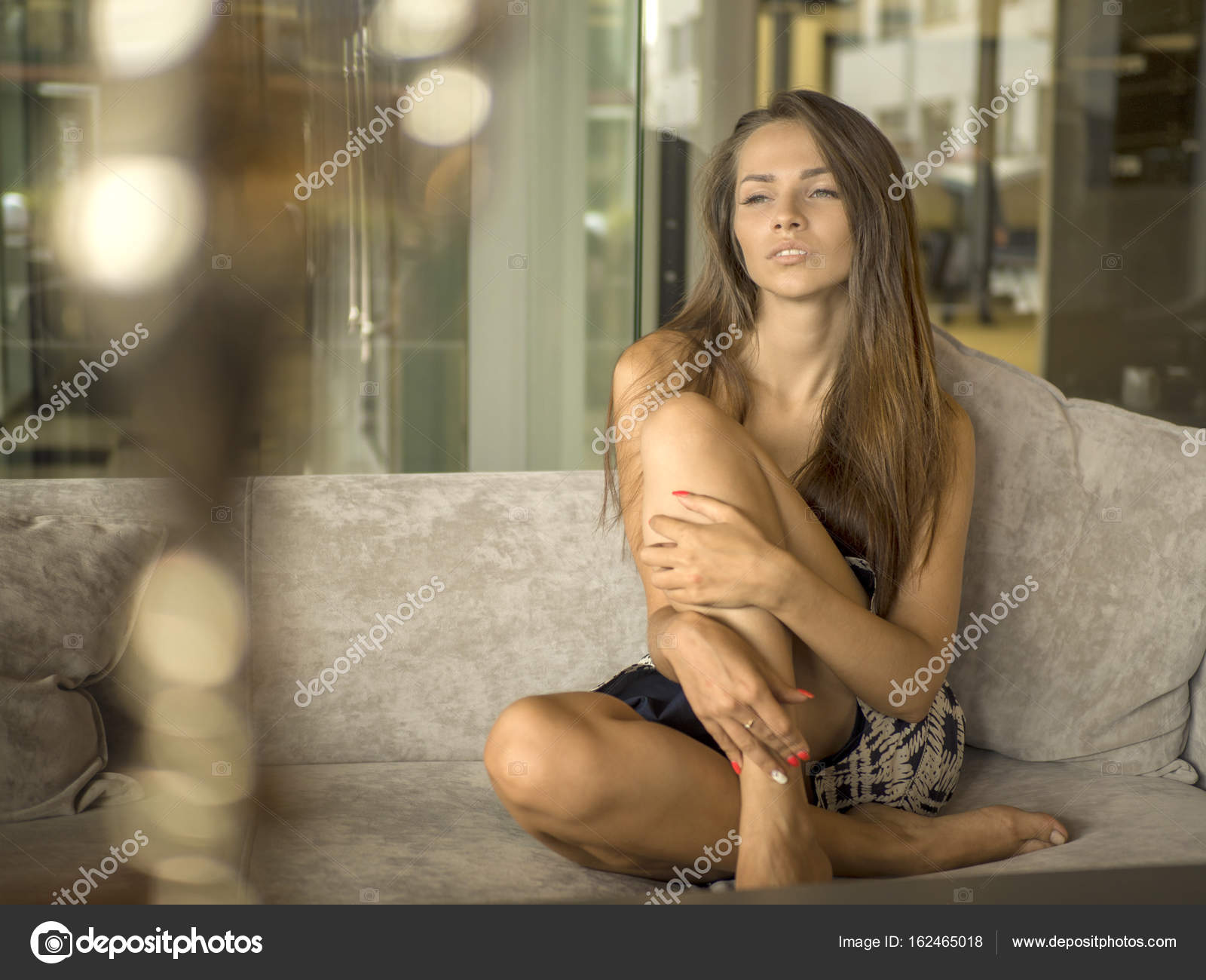 Above view pretty woman in short dress sitting on terrace in ...