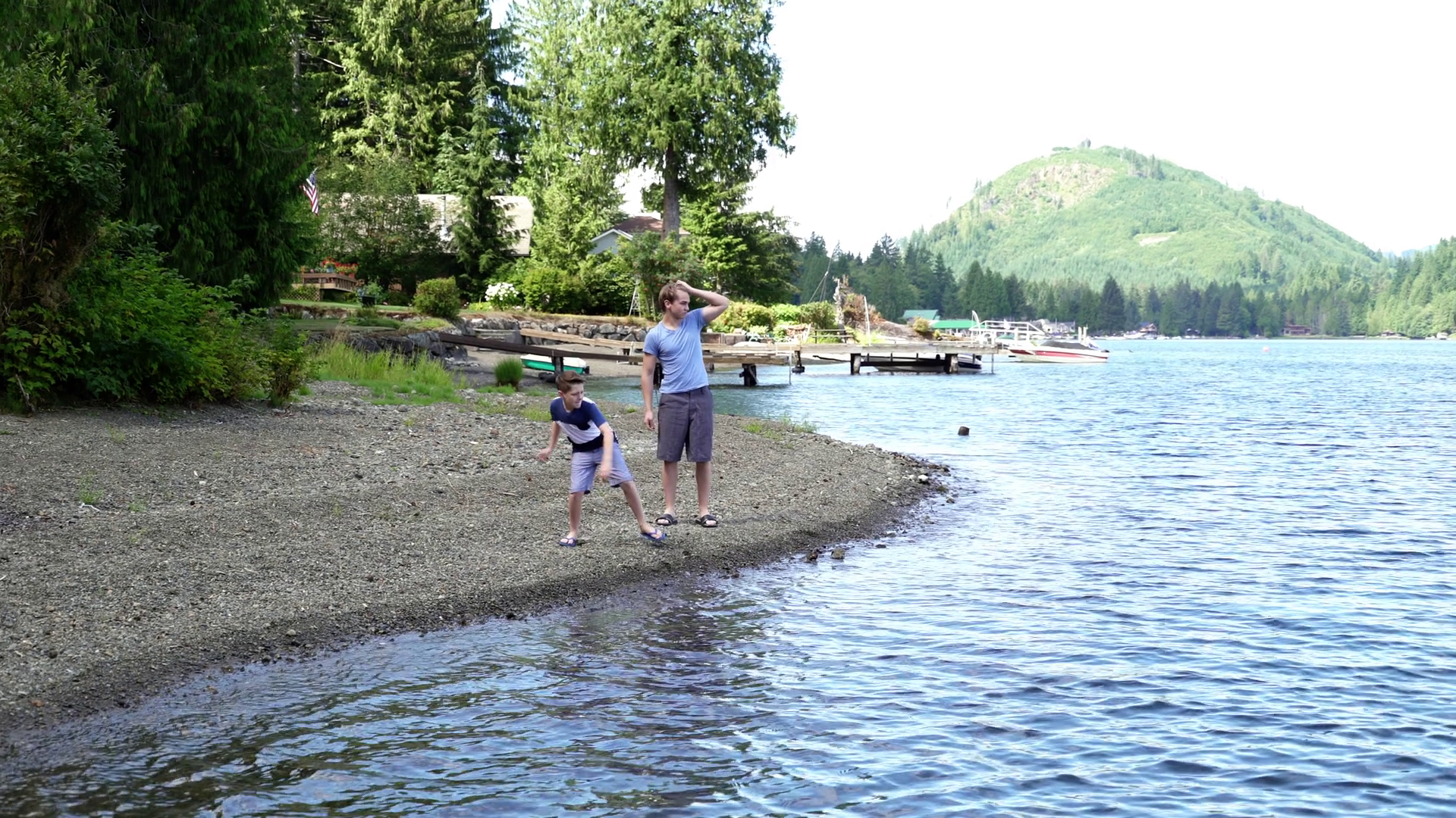 Two brothers skimming stones by Lake Connaught, Washington, USA ...