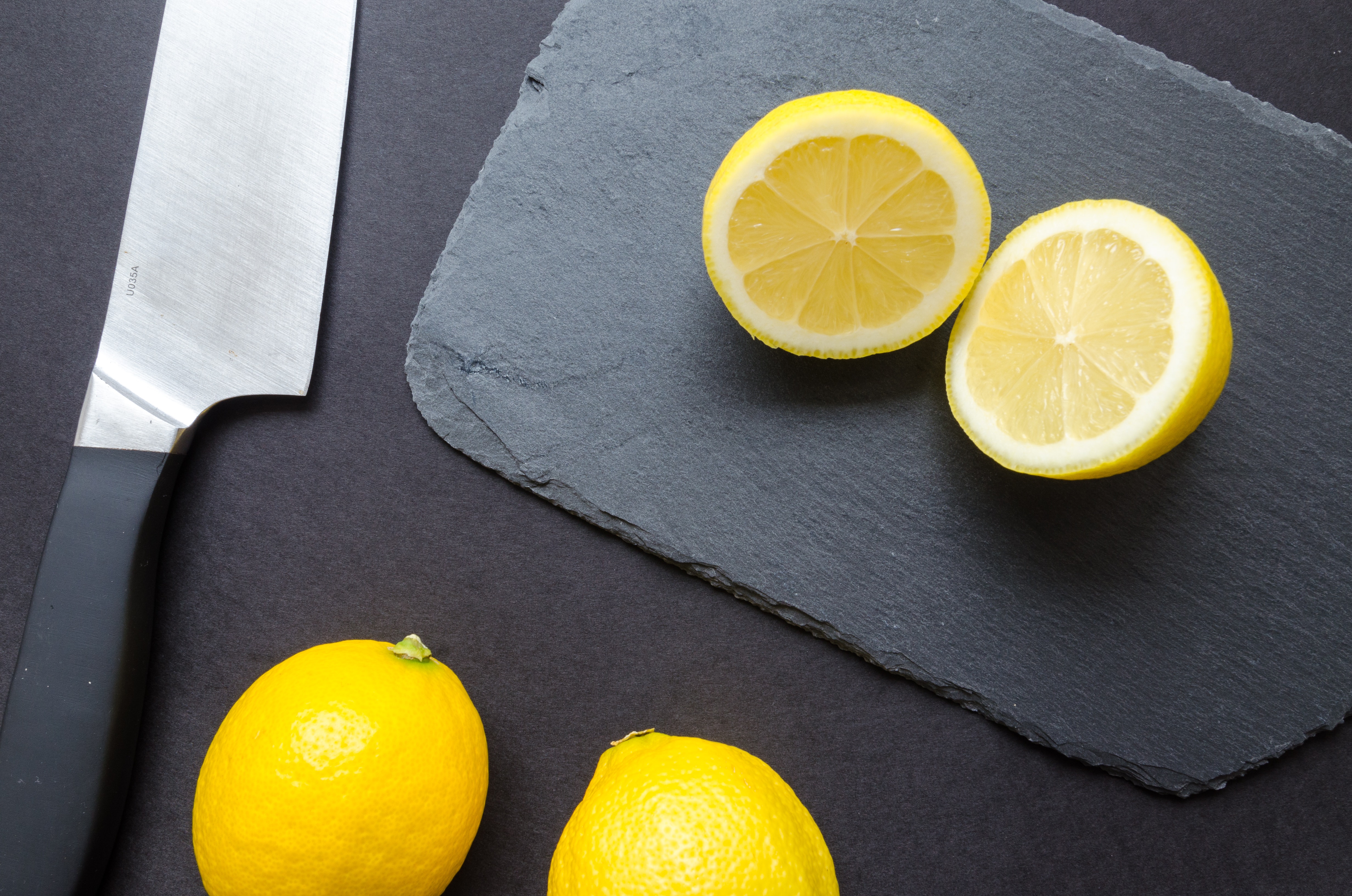 Sliced lemons on black surface photo
