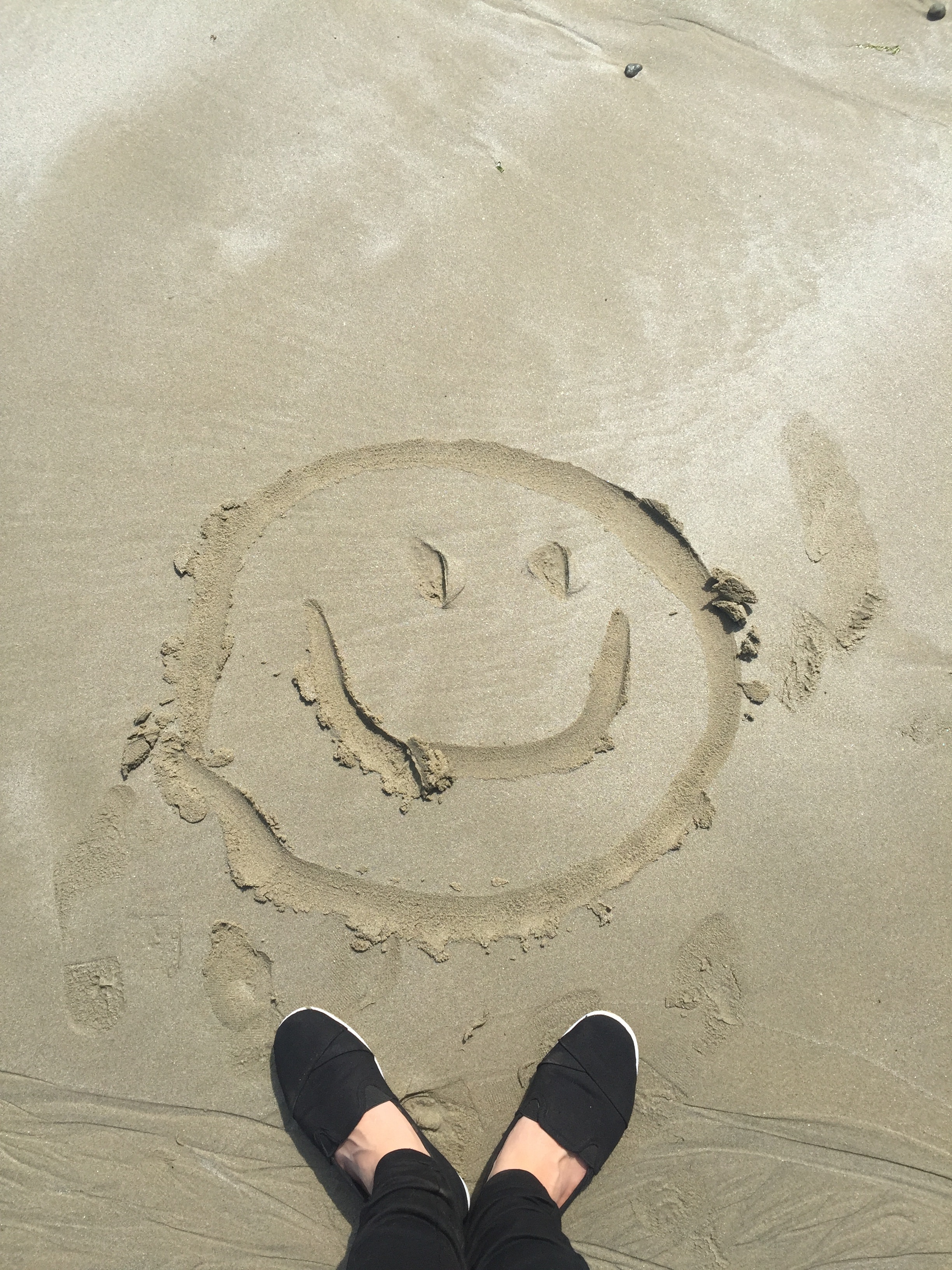 Smiley drawing on sand photo