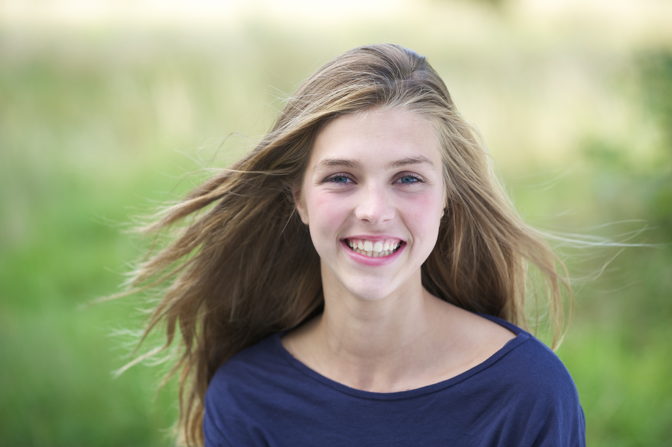Portrait of a pretty teenage girl outside smiling - Amazing Farm. 