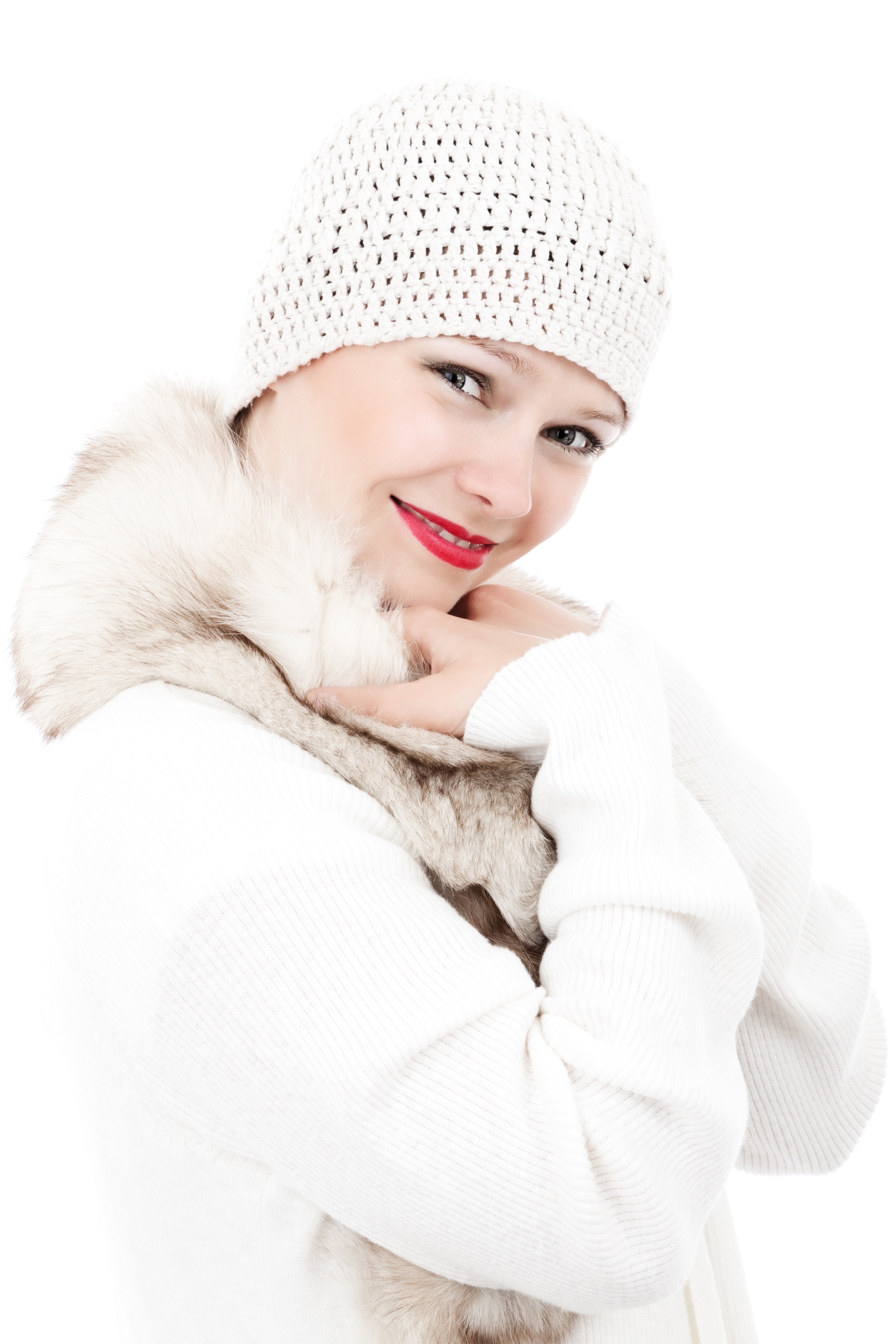 Smiling woman wearing white knit cap and white and beige fur lined coat photo