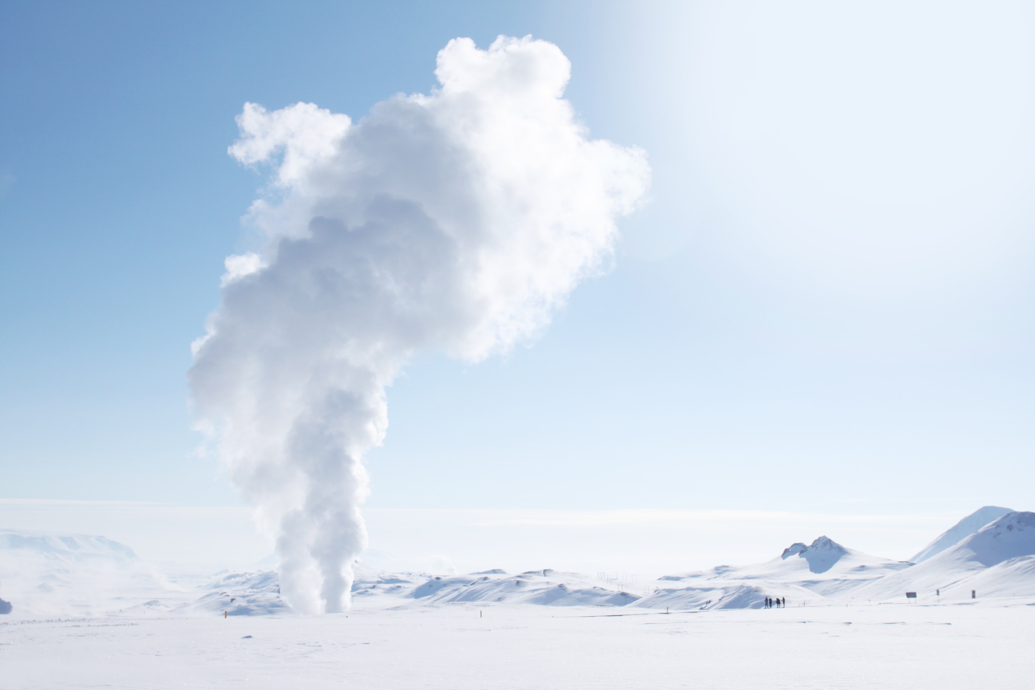 Smoke rising from snow-covered field photo