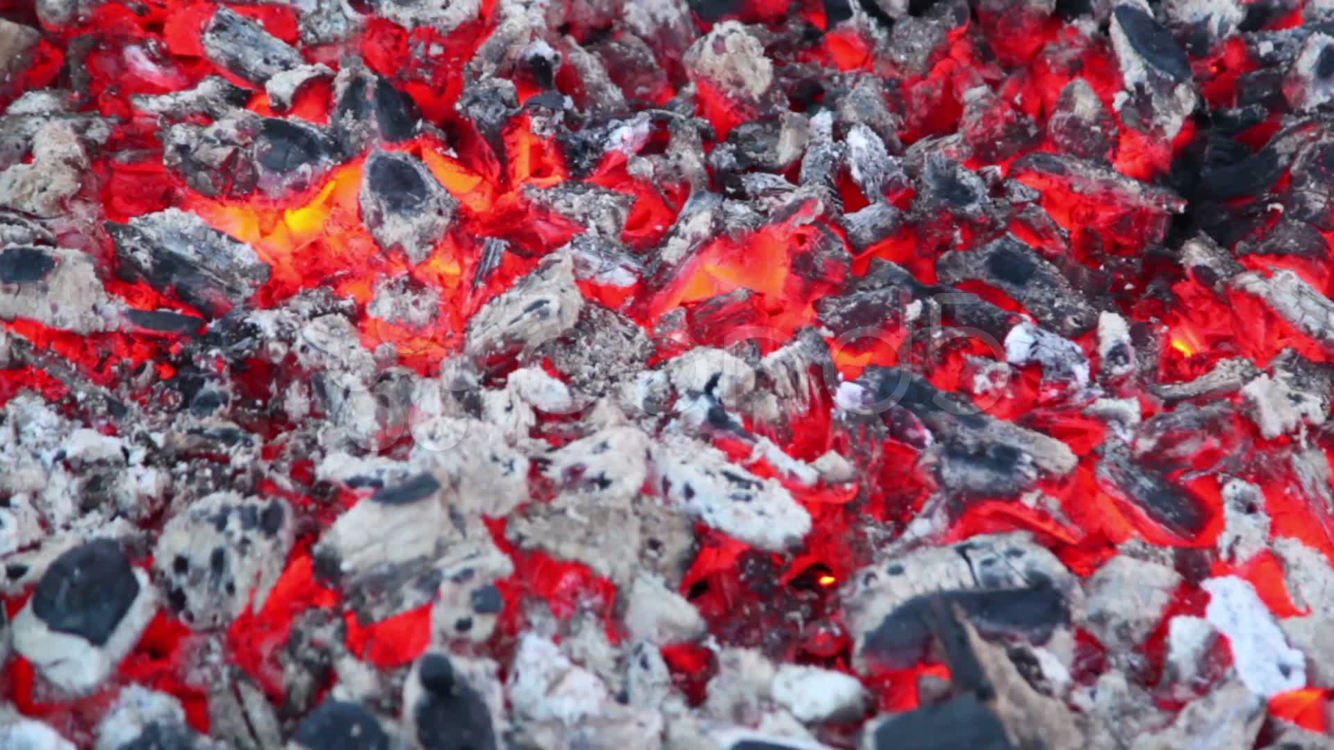 Smoldering embers with small amount of smoke and fire ~ Clip #10568422